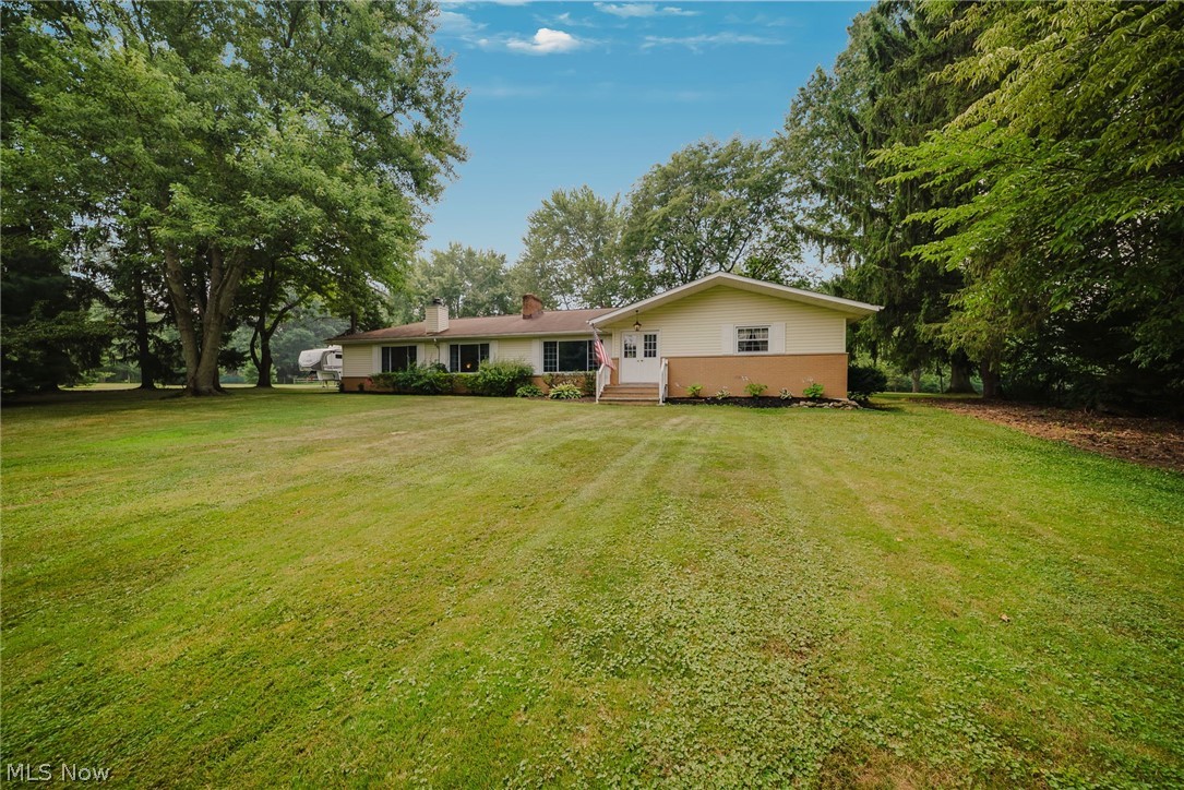 Tucked away on nearly three private acres in Valley City, this beautifully maintained sprawling ranch combines the comfort of home with the space and flexibility of country living. Inside, you'll find 2,118 square feet of comfortable living space, including two distinct living areas that provide flexibility for both everyday living and entertaining. The oversized family room, anchored by a beautiful fireplace, is the heart of the home with plenty of room to gather, relax, and unwind, while the inviting living room offers an additional space to entertain or enjoy a quiet evening. The updated kitchen features a large center island, luxury vinyl tile flooring, and sliding doors that lead directly to the deck overlooking the peaceful backyard. Additional fireplaces add warmth and character to the home, including one in the walkout basement. The home offers three bedrooms and two and a half bathrooms, including an updated primary bath. The unfinished walkout basement provides exceptional storage today with endless possibilities to create additional finished living space in the future. Outside is where this property truly shines. Surrounded by mature trees with a blend of open lawn and wooded privacy, you'll enjoy room to entertain, relax, or simply appreciate the peaceful setting. The impressive 30' x 40' barn with electric service, a durable steel roof, and a covered canopy offers outstanding flexibility for projects, cars, boats, ATVs, equipment, hobbies, or workshop space, while a dedicated parking area provides room for your RV. An attached 24' x 26' garage with an 18-foot-wide door adds even more convenience. Whether you've been dreaming of leaving the neighborhood behind, need room for your hobbies, or simply want a property that offers more freedom, this home delivers the privacy, versatility, and acreage that's becoming increasingly difficult to find. Schedule your private tour and experience everything this special property has to offer.