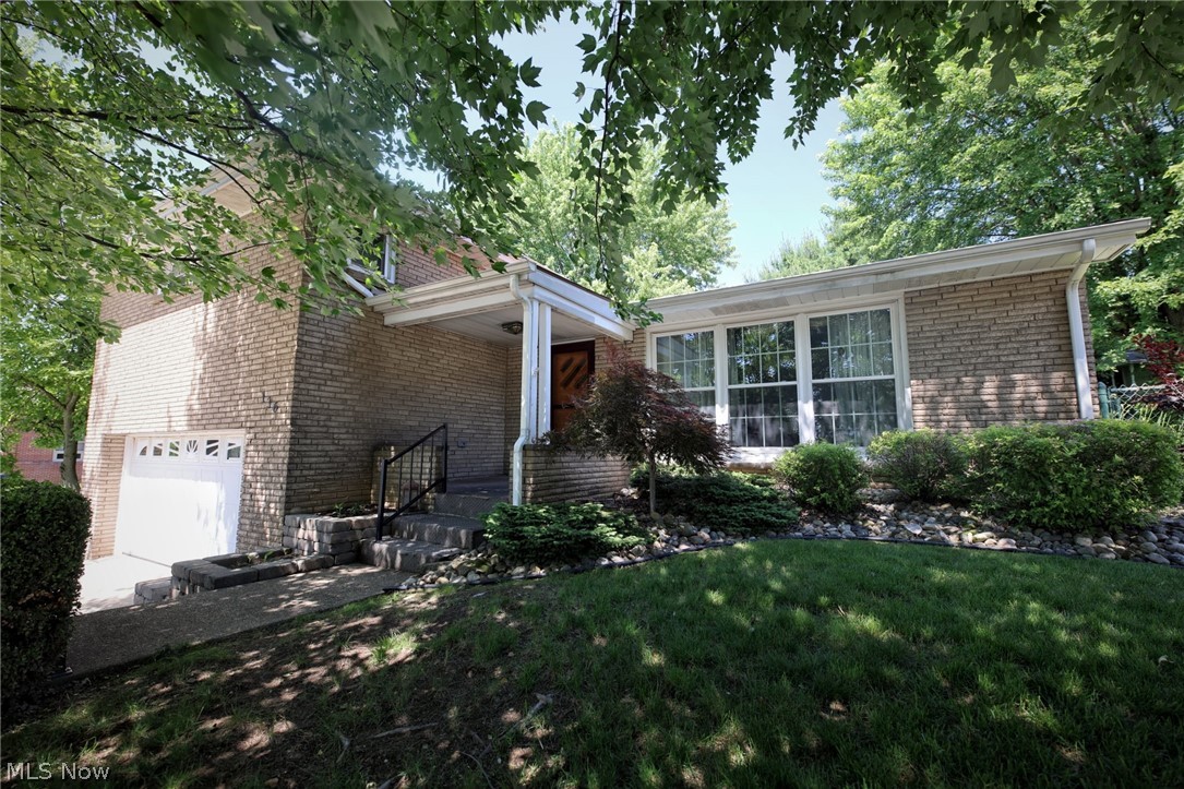 Situated on a corner lot this wonderful 3BR, 2.5BA brick home located in Weirton, WV has so much appeal you won't be able to resist. 
The charm and warmth are apparent as soon as you enter the very spacious living room that flows into the equipped kitchen with so much cabinetry clutter will be a thing of the past. Just off the dining area you're lead onto the beautiful covered patio and fenced  yard that offers privacy and a perfect spot to end your day. The three spacious bedrooms with ample closet space and two full bathrooms complete the second level. Steps away is the family room with gas log fireplace just off the 2 car garage. Need storage? The full basement has more storage than you ever wished to find. The newer whole house Generac generator, vinyl replacement windows, gutters, downspouts and newer appliances are just some of the upgrades this gem of a find has to offer. Don't wait to call before this one is gone.