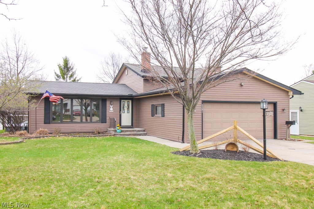 Welcome to this well maintained split level home.  On the main level you will find an open concept living room, kitchen, and dining room with wood beamed cathedral ceilings.  Second level you will find all three bedrooms, and full bath.  Master bedroom also has access to a new outside balcony.  One the lower level you will find a partially finished family room, laundry room, half bath, access to the garage and tons of storage.  Schedule your appointment today this one won't last long!!