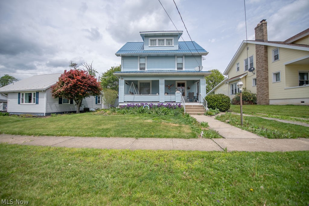 Welcome to this charming two story home, complete with a metal roof and a welcoming covered front porch with classic curb appeal.
Step inside to beautifully preserved original oak woodwork, custom built-ins, and warm character that carries through the living room into the dining room.  The kitchen offers a practical layout with plenty of opportunity to update to your style.  Upstairs, you will find spacious bedrooms, each with generous closet space.  Full bath featuring a bathtub and a separate shower for added convenience.  A walk up third floor provides a large attic space currently used for storage with potential for a finished living space, studio or a quiet retreat.  Outside enjoy a landscaped yard with seasonal blooms, detached garage and a location close to parks, schools and all local amenities.  This is a classic home that blends authentic craftsmanship with comfortable practical living.