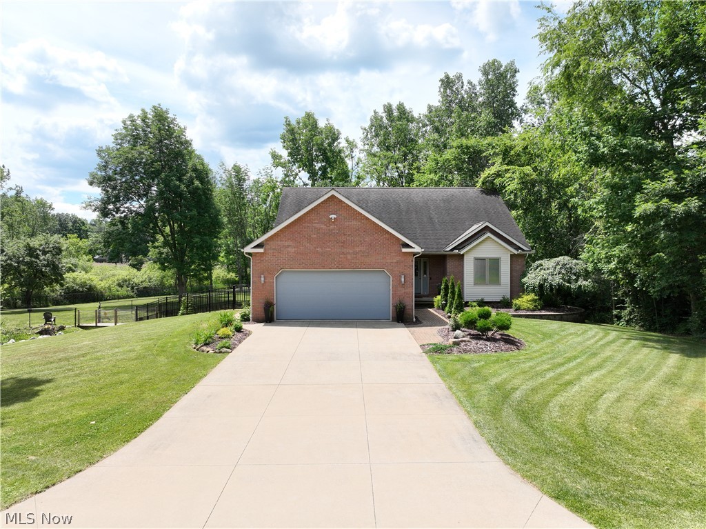 This Elegant Contemporary home w/a 1st Floor Master Suite sits on 3.27 acres of Natural Beauty, alive with wildlife, deer, etc. and features a newly built bridge over a creek. The fenced park-like yard has been carefully excavated and beautifully landscaped, complimenting a charming stone patio that overlooks the backyard's peaceful beauty that is enhanced by occasional visiting wildlife, yet just minutes from shopping, entertainment and highway access. A Gorgeous, Open Floor Plan greets you in the spacious foyer w/ plush carpeting throughout the living room and dining area that shows off custom built-ins and French Doors to your private backyard retreat, while the Family room shines w/a gas fireplace and overlooks the serene backyard as well. A Delightful kitchen that offers 6-burner Viking gas range with hood and dual ovens, an island w/a prep sink and plenty of cabinetry, a pantry, storage and a 1st floor 1/2 bathroom *Lovely Wood Flooring is in the Kitchen, Laundry, Half Bath & under the carpeting in Living room, Dining area and Family Room* The first-floor Master suite includes a back yard view w/ private entry to the patio and a newer full Bathroom w/a big walk-in tile shower. The large first-floor office can also serve as an addl' 1st floor Bedroom adorned w/ rich built-in cabinetry. A convenient first-floor laundry offers extra shelving  & mudroom access to the garage. The Upstairs provides privacy w/ two spacious bedrooms, each with dual closets, a second office or bonus room and 2nd full bathroom. Extras include recessed lighting, solid hardwood doors, Pella casement windows and a whole-house fan. Since 2020, updates include a new garage door, fencing, landscaping, patio, bridge, large Shed, Gas Furnace and Central A/C, gutter guards, some carpeting, and exterior lighting. The full basement includes a private walkout to the garage, perfect for storage and convenience!!