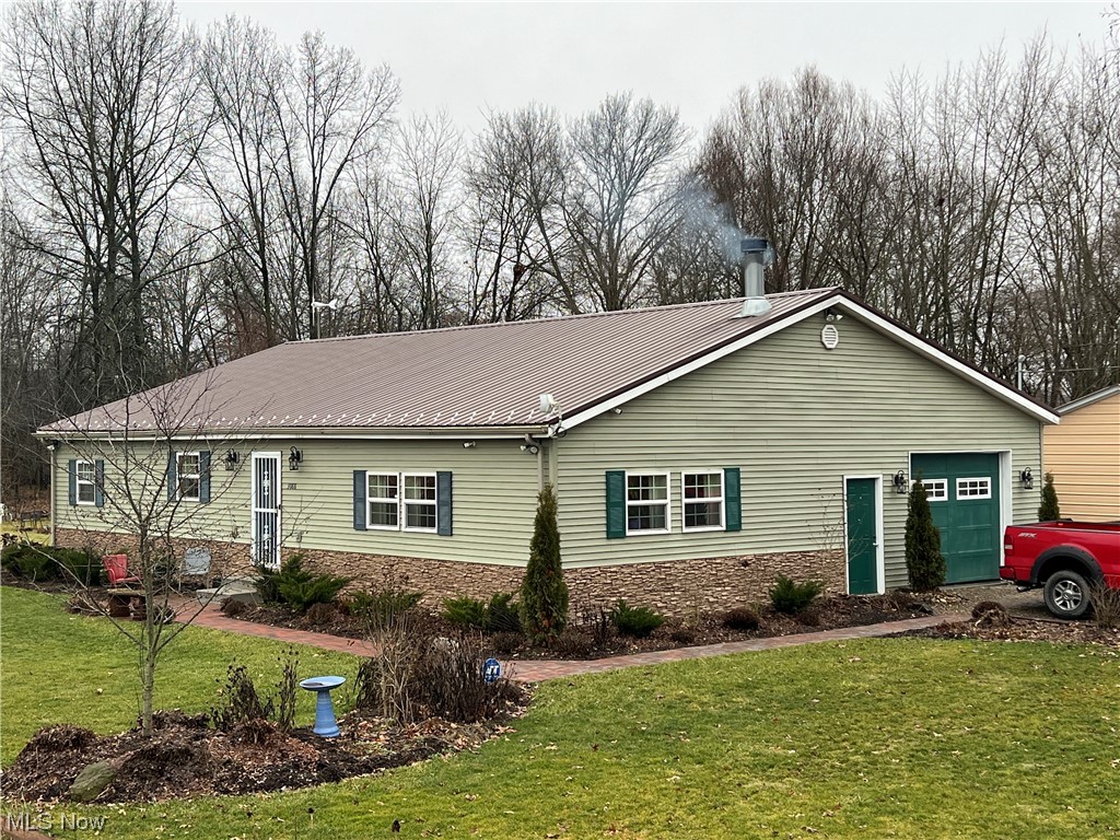 Preppers, gardeners, and horticulturists take note! Come take a look at this 4 bedroom, 2 bath ranch home with an 832 square foot attached greenhouse with pond and wood burner. This newer home was built in 2016 and has 1544 sq. ft. of living space on a crawl space, engineered hardwood flooring throughout (except pantry and baths) and a steel roof. The home has a large living area with woodburning fireplace, kitchen with hickory cabinets and concrete countertops and includes the stove, fridge, and dishwasher, large pantry area, 4 bedrooms, 2 full baths, and laundry area. The attached one car garage has a newly built concrete safe room. There are 2 water wells (county water is available) and county sewer. Heat is electric and wood burner. The wood burner heats the home and the greenhouse plus the pond water where Tilapia fish are raised. Many plants will remain in the greenhouse including banana trees! There is also a chicken coop, turkey house, above ground pool, and large garden area. Tree-lined double corner lot. A great opportunity here!