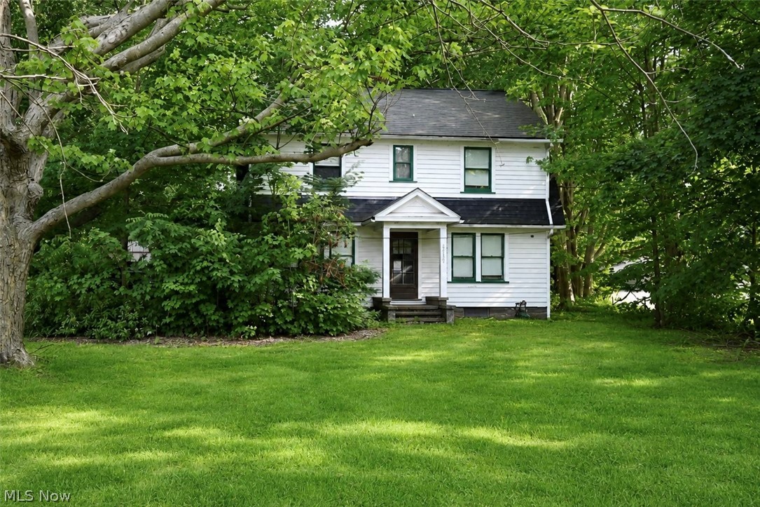 Rare opportunity in the heart of Mentor! Nestled on approximately 2.75 acres along Lakeshore Boulevard, this property offers endless potential for the right buyer. Owned by the same family for more than 125 years, this home is ready for its next chapter and awaits restoration to its former charm.

Offering approximately 2,000 square feet of living space, the home features four bedrooms on the second floor and a possible oversized primary bedroom on the main level. The expansive lot provides plenty of room to enjoy privacy, recreation, or future possibilities.

A standout feature is the impressive 1,680-square-foot outbuilding, complete with two front garage doors and one rear garage door, allowing convenient access to the acreage behind. Whether you're a hobbyist, contractor, collector, or simply need exceptional storage space, this building offers tremendous versatility.

Located just minutes from Mentor's beaches, parks, shopping, and amenities, this unique property combines a desirable location with acreage and opportunity. Additionally, a separate home situated on an adjoining quarter-acre parcel may present an ideal option for those seeking a multi-generational living arrangement. Bring your vision and unlock the potential of this one-of-a-kind property!