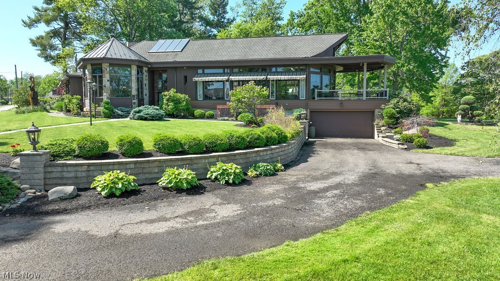 Welcome to one of Atwood Lake’s most unique and historic waterfront properties! This property is situated on the historic site originally occupied by the church that once overlooked Atwood Lake. This incredible cedar and stone home has been transformed into a truly one-of-a-kind lakefront retreat filled with character, craftsmanship, and breathtaking panoramic lake views.  Situated on a premier waterfront lot with private beach access and dockage, this property offers the ultimate lake lifestyle. The spacious interior features 3+ bedrooms, 5 full baths and 1 half bath, soaring ceilings, exposed wood beams, custom cherry cabinetry, beautiful woodwork throughout, and a dramatic circular foyer with solarium-style ceiling. The expansive living room captures stunning views of the lake and creates the perfect setting for relaxing or entertaining around the home’s stunning fireplace.  The finished lower level offers additional living and recreation space complete with a wet bar, while the outdoor entertaining areas include an expansive patio, outdoor kitchen space, and private dock access to beautiful Atwood Lake. Attached and detached garages provide plenty of storage for lake toys and equipment.  
Atwood Lake is well known for boating, fishing, kayaking, swimming, hiking trails, marinas, restaurants, and year-round recreation. Whether you’re searching for a full-time residence or the perfect waterfront getaway, this remarkable property offers history, charm, and lakefront living that simply cannot be duplicated. Truly a must-see property to appreciate everything it has to offer!