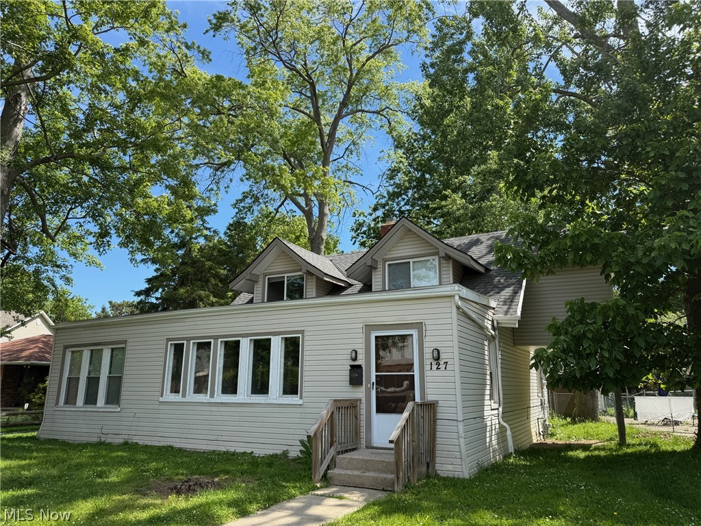 This updated Cape Cod offers 2,086 sq ft of living space on a 0.25-acre lot in the City of Euclid. Set north of Lakeshore Blvd, 127 E 270th St is close to Lake Erie, local shopping, dining, parks, medical services, and RTA transit along the Lakeshore corridor. The main level includes a large living room with wood flooring and a fireplace, a formal dining room with a built-in cabinet, and an updated kitchen with maple cabinets, vinyl/LVT flooring, generous counter space, dishwasher, and microwave. Possible 1-floor living with two first-floor bedrooms and an updated full bath. Upstairs, two additional bedrooms, a full bath, an office, and a bonus room provide flexible space for work, storage, hobbies, or guests. The 22 x 10 four-season sunroom adds bright everyday living space with walls of windows. Additional features include central air, newer furnace, upgraded electrical, vinyl siding, vinyl windows, basement laundry, a partial unfinished basement for storage, an oversized 2-car garage, and off-street parking for 4 or more vehicles. Great for owner occupants or investors, rent conservatively estimated around $1500-1600/mo.