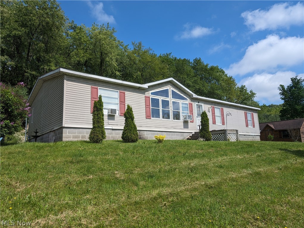 Check out this little piece of heaven, centrally located to Calcutta and East Liverpool, and minutes to Rte 7 and Rte 11.  This manufactured ranch home sits on 8 acres, with a fully stocked pond and hunting land behind the home.  There is a large 15x24 log style shed and another small shed.  All mineral rights convey.  The home features an en suite with large soaking tub and a beautiful wood fireplace in the family room.  There is a handicap accessible ramp built to the rear covered porch.  Dishwasher, stove , washer ,dryer and hot water tank are all newer.  The central AC does not work, but window units will stay.  A lot of the furniture is negotiable.