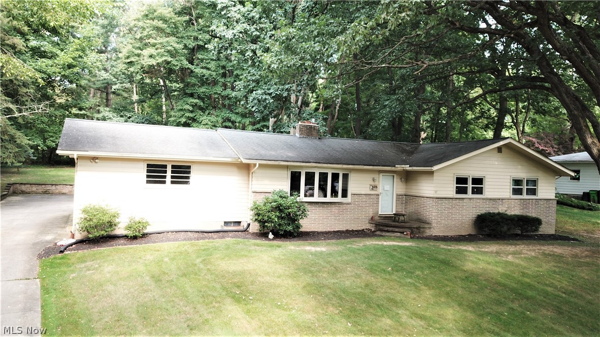 Spectacular find in Tallmadge! This well maintained 3 bedroom ranch sits on a large private lot, and on a quiet street. Wooded backyard features a pavilion, creating a true park like setting. Other great features worth noting include: beautiful hardwood flooring, high- quality vinyl replacement windows throughout the home,  spacious bedrooms, kitchen soon to be with brand new stovetop and refrigerator. Finished basement with bright oversized laundry room. 2 car rear facing attached garage. So much to love about this one! Don't miss out on this great opportunity. Call today for your private tour