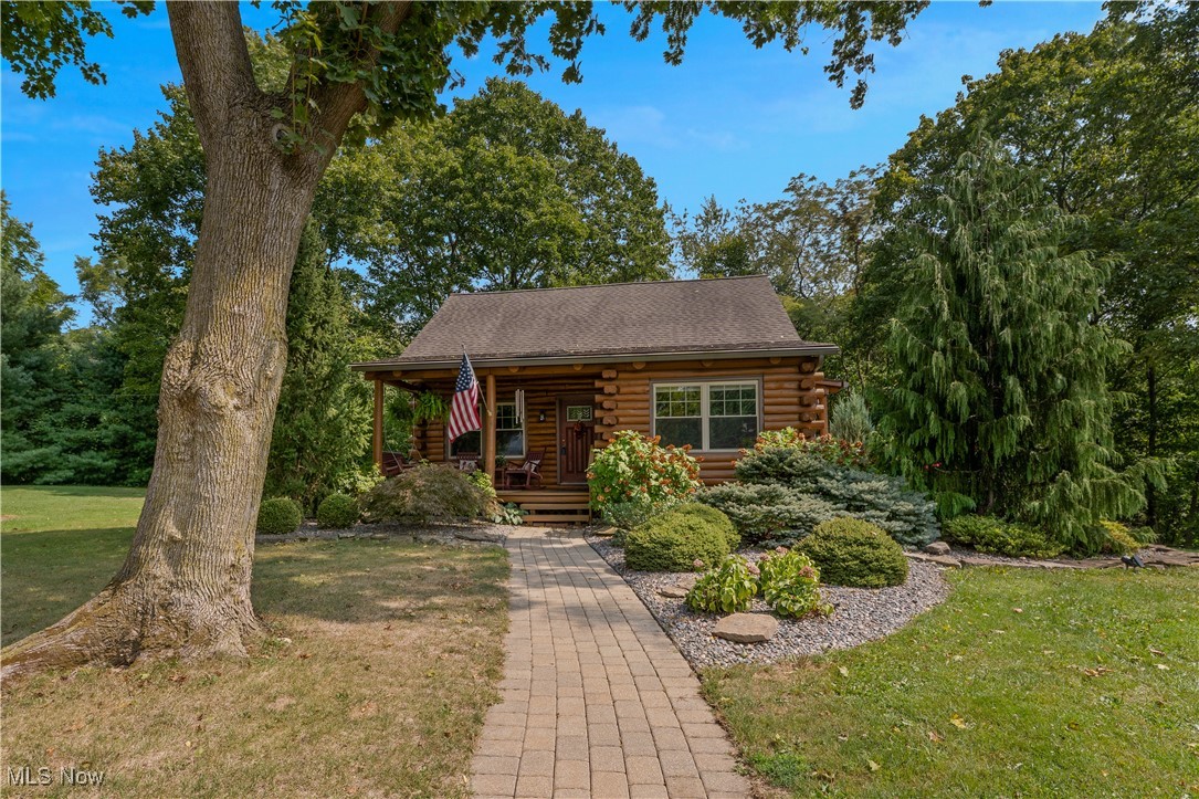 Here's your golden opportunity for that once in a lifetime home.  Total log cabin!!  Located on the most serene setting you can find!!  Not only that, it's been completely updated!  New kitchen and stove...1 yr old! Furn/AC less than 5 yrs old! Roof 12 yrs old (all wood replaced) Larger gutters added with Anderson K guards.  Windows 12 yrs! HWT (2/25)  Water softener and filtration system newer.  Main bath remodeled 2 yrs ago along with 1/2 bath! Smoke alarms are new with 10 yr warranty.  Remodeled bath in the basement also. Garage door openers 6-7 yrs old. Then there's the backyard!!  Multi-level decks over looking the beautiful scenery.  Waterfall in the distance.  Oversized garage!!