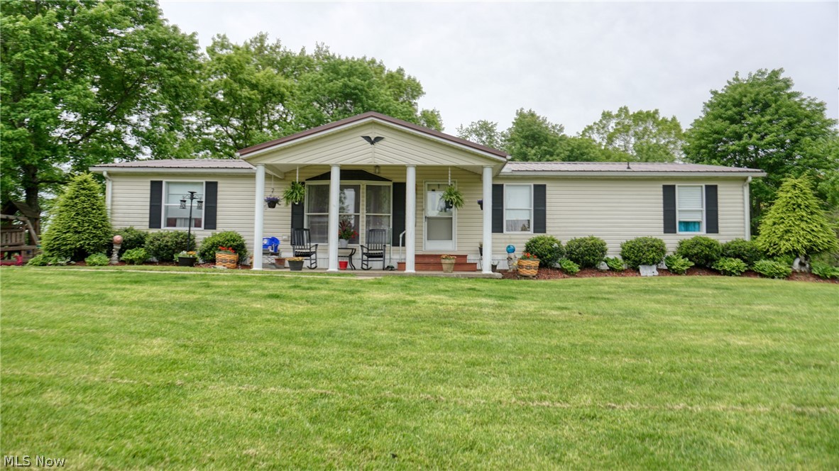 Newly remodeled 3 BR, 2 BA manufactured home on almost 8 acres-new metal roof, new deck, new floor coverings, 16 KW Generac Generator heat pump, propane heat. 30 x 42 detached garage w/ loft.  Small livestock barn 16' x 32- 1 acre fenced, beautifully landscaped.