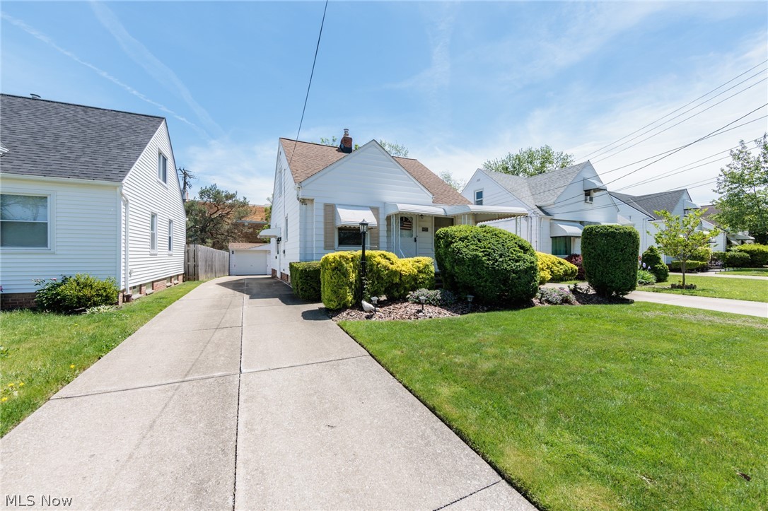 Welcome to 6025 E. 135th! Please know this is not a flipped home-- It is a home that has been lovingly taken care of by Mrs. Clean for the past 51 years! ONE OWNER  for 51 years. Their are 2 bedrooms on the 1st floor along with the kitchen,( Corian  countertops) dining, living room & full bath that includes an old fashioned cloths chute. The 2nd floor offers a large bedroom, which includes built in dresser drawers with additional space for hanging cloths. The 2nd floor also has a walk in storage area, along with a half bath. The partially finished basement includes a gas wall fireplace along with a vintage bar. Laundry area is located in the basement & includes a counter area to fold cloths. Located on a quiet residential street with access to shopping, dining, parks and major freeways. The best thing about this home( besides how well its been maintained) is the roof was replaced 2 weeks ago June 2026, the AC was replaced April/May 2026, Electrical panel replaced 2026, hot water tank replaced 2026 & the furnace was replaced within the last 4-5 years. Gutters &  Windows have been replaced except for 2, do not know exact date.   PEACE OF MIND. The home includes a  detached 2 car garage, along with a good size covered front porch, along with a very cared for yard. Large outdoor area for entertaining, grilling etc.  Stove, dishwasher, refrigerator, washer and dryer, microwave with stand stay with the home, as do all window treatments. This property checks a lot of very costly boxes. The city of Garfield Heights has much to offer in the way of a Rec Center, Senior Center & outdoor pool.  Schedule your showing today. Make Mrs. Cleans Day.