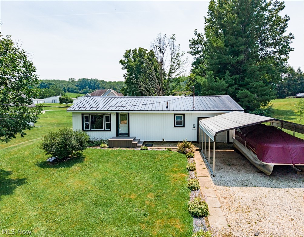 Offered for sale is this charming Atwood Lake home situated on a spacious double lot, just a short walk from the dock! Featuring updated vinyl siding and a durable metal roof, this home offers a welcoming open-concept layout with a large kitchen complete with a breakfast bar, a spacious dining and living area, and a generous entry room highlighted by a cozy fireplace. With three bedrooms, a full bath, and a convenient laundry room, there's plenty of space for family and guests. An 18' x 20' carport provides covered parking, making this an ideal weekend retreat or year-round home where you can enjoy fishing, swimming, and all the recreational opportunities Atwood Lake has to offer.