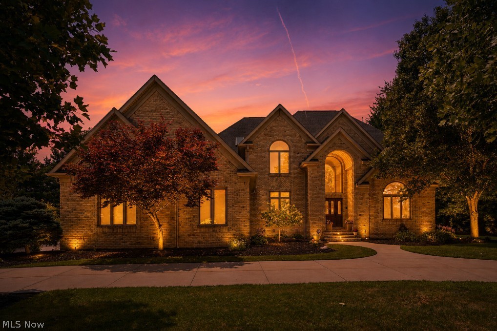 Welcome to this exceptional 4-bedroom, 5.5-bath brick Colonial in the highly sought-after Crystal Shores neighborhood of Bath Township, located in the award-winning Revere Local School District. Nestled on a quiet cul-de-sac, this home is designed for both everyday living and unforgettable entertaining. The backyard is a true resort-style retreat, featuring an in-ground pool and spa, expansive travertine patio, outdoor kitchen, and a tranquil koi pond with cascading waterfalls—the perfect setting for summer barbecues, pool parties, or crisp fall evenings spent watching football outdoors. Inside, you'll find a thoughtfully designed floor plan with a sun-filled four-season room, Great room with fireplace, private office/library, formal living and dining rooms, and a chef's kitchen with breakfast nook. A spacious laundry room and half bath complete the main level. The second floor offers a luxurious primary suite with its own fireplace, along with three additional generously sized bedrooms, each with its own private en-suite bath. The walkout lower level adds over 2,000 finished square feet of living space, complete with a family room featuring a fireplace, large bar, billiards room, salon/flex room, full bath, and an impressive 12-foot sliding door providing direct access to the backyard and pool. Additional highlights include a 3-car side-entry garage, circular driveway, and exclusive access to Crystal Lake, where residents can enjoy paddleboarding, pedal boating, fishing, and more. Conveniently located just minutes from Montrose, I-77, Route 21, and I-71, this is a rare opportunity to enjoy luxury living in one of Bath Township's most desirable communities.