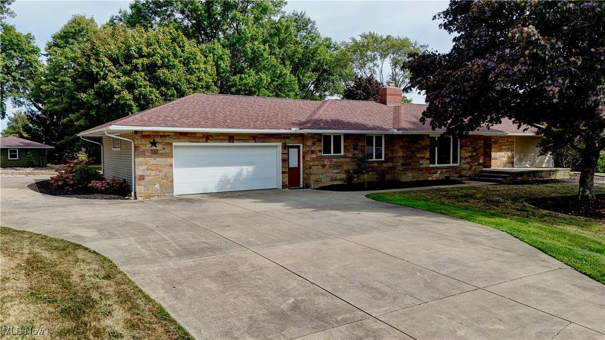 Welcome to 2982 Homeworth Road! This 3 bedroom 2.5 bathroom ranch home has everything you're looking for both indoor and out! The open kitchen features a separate coffee bar and pantry with sliding drawers! Off of one side of the kitchen is the den, sure to WOW with its beautiful wooden cathedral ceiling and fireplace feature! Off the other side of the kitchen you will find space for formal dining as well as a large living area complete with large windows letting in the natural light while allowing you to take in the stunning views! The primary suite is very spacious complete with walk in closet! The en suite bathroom features a soaking tub and stand alone shower with two separate sink and vanity areas! Two additional rooms and a full bath are just down the hall! With first floor laundry and an additional half bath, you'll need for nothing more on the main level! Outside you not only have your attached 2 car garage complete with electric car charger, but also an additional standalone 4 car garage! As if that does not provide enough space don't forget to check out the outbuilding which has been redone and converted into a perfect hangout spot! With over 2.5 acres, a fire pit, and a swimming pool, you really have your own outdoor oasis! Call today to schedule a private showing!