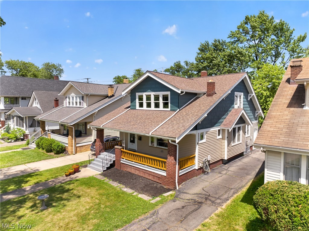 Timeless 1923 Lakewood bungalow brimming with original character & thoughtful updates. A full-width covered porch welcomes you into a light-filled living room with rich hardwood floors, handsome oak woodwork, leaded glass transoms & a brick fireplace flanked by built-in leaded glass cabinets. Graceful arched openings lead to a formal dining room with a built-in buffet & period woodwork throughout. The updated kitchen offers stainless steel appliances, ample oak cabinetry, tile backsplash & a walk-in pantry/mudroom opening to the rear. Two bedrooms & a full bath complete the main floor. Upstairs, a private primary suite stuns with vaulted ceilings, an oversized walk-through closet & an attached full bath, joined by a spacious additional bedroom. The full basement delivers abundant storage, laundry & workshop space. Newer roof, central air & a detached 2 car garage. Many furnishings, including the oak dining set & period pieces, kitchen appliances & washer/dryer, convey — move right in. Set in southwest Lakewood near Madison Park, the Madison Ave coffee & dining corridor & Lakewood City Schools.

Seller reserves the right to not respond to offers until the property has been on the market for five days.