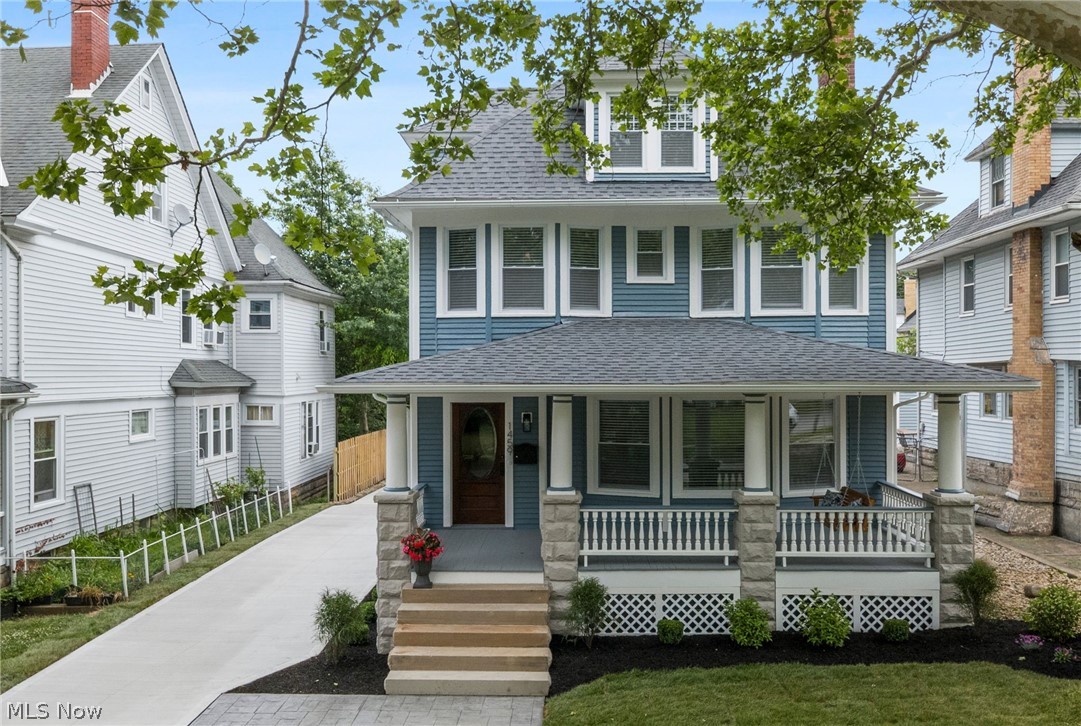 Welcome to this beautifully reimagined Lakewood gem, where old-world charm meets modern sophistication. Meticulously renovated with exceptional attention to detail, this stunning home showcases gorgeous original woodwork, timeless architectural details, and thoughtfully curated updates that complement its historic beauty. From the moment you step inside, you'll appreciate the warmth and character that make this home truly one of a kind. Beautiful curb appeal welcomes you home, highlighted by the inviting covered front porch with a swing and a stunning wood entry door featuring an elegant oval glass insert. The welcoming foyer leads into a spacious living room with large window and a gas log fireplace with a marble surround. Framed by gorgeous original woodwork, the living room flows effortlessly into a stunning open dining area and chef's kitchen, creating one expansive space perfect for everyday living and entertaining. Anchored by a show-stopping chandelier, this impressive space features white shaker cabinetry, a marble herringbone backsplash, stainless steel appliances, quartz countertops, a center island with seating, and charming built-in window benches that add both character and functionality. A half bath completes the main level. The beautiful staircase leads to the second floor, where the owner's suite offers a walk-in closet with a custom organization system and a luxurious en-suite bath with ceramic tile flooring, a double vanity, and a walk-in shower. Two additional bedrooms and a beautifully updated full bath with a double vanity and tub complete this level. The third floor offers a spacious fourth bedroom filled with natural light. Your living space continues into the finished lower level with a recreation room, fifth bedroom, full bath, laundry and storage area. Enjoy summer cookouts or relaxing evenings on the back patio with plenty of room for gardening in the partially fenced yard. Detached two-car garage. Call us today to schedule time to see it!