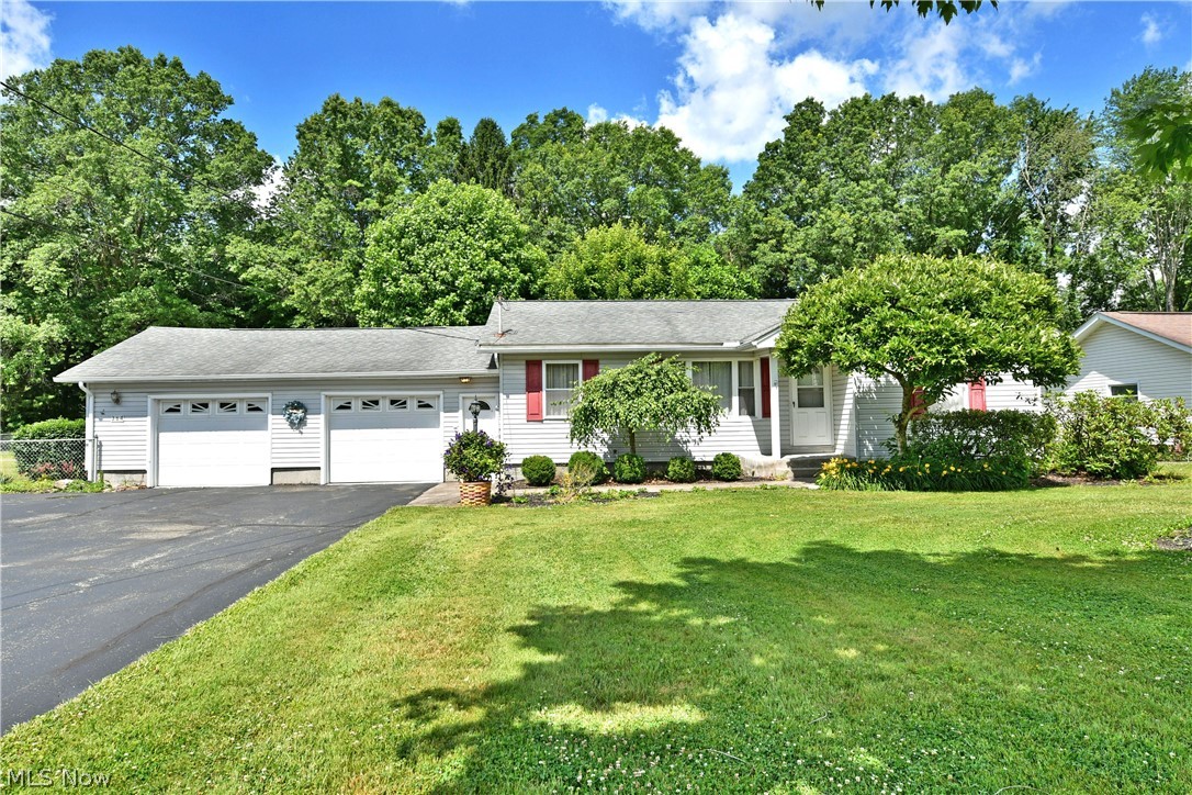 Hurry in, this must-see Vienna ranch won’t be here for long! Showcasing an expansive property, the frontage includes a second drive leading to an additional two-car garage, bringing the total bays to four. The fenced-in backyard brings park-like views with its immersive landscaping, pergola topped swing and finished sunroom for four-season relaxation. Step inside the home to find a spacious front great room that combines both living and dining spaces, partitioned by flooring changes; from plush carpets to warm hardwood style offerings. The large picture window ensures plenty of sunshine to brighten your days. The galley kitchen tucks in along the far corner near both basement and garage access. Opposite the living room, a trio of bedrooms branch from the wrapping hall. They are joined by a brightly lit full bath and its tasteful updates to include a glass door shower and stone topped vanity. Down below, the full basement provides additional finished living space in the form of a family or rec room. Around the corner, a sizeable full bath completes the package along with offset laundry and utility access.