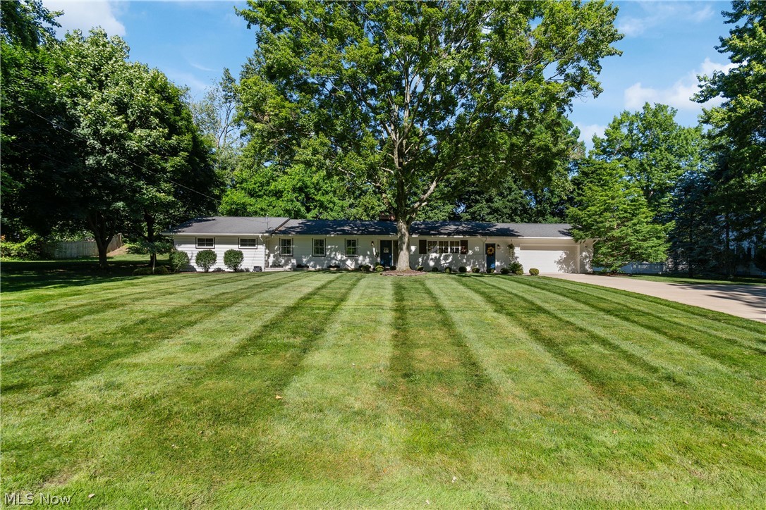 Welcome to 1001 Oneida Trail SW in desirable Lake Local Schools! This beautifully updated 4-bedroom, 3 full-bath home offers over 2,700 square feet of finished living space and a layout designed for both everyday living and entertaining. The heart of the home is the open-concept main living area featuring quartz countertops, a large center island, stainless steel appliances, abundant cabinetry, and seamless flow between the kitchen, dining, and living spaces. The inviting living room is filled with natural light from oversized windows and showcases a stunning brick fireplace as its focal point. Just beyond the main living area, you'll find a spacious climate-controlled four-season sunroom that overlooks the private backyard. Step outside to the patio and enjoy the peaceful setting complete with a pathway leading to a cozy firepit area. A thoughtfully designed mudroom with custom built-in storage helps keep daily life organized. The primary suite offers a private ensuite bath, while three additional bedrooms and a conveniently located first-floor laundry room provide functionality for today's lifestyle. The finished lower level expands your living space with a second fireplace and flexible areas perfect for a recreation room, home office, fitness area, or media room. Ample storage and built-in shelving provide plenty of room for organization as well. Situated on a beautiful lot in a sought-after location, this move-in-ready home combines modern updates, generous living space, and exceptional indoor-outdoor living. Don't miss your opportunity to make this Lake Township property your next home!