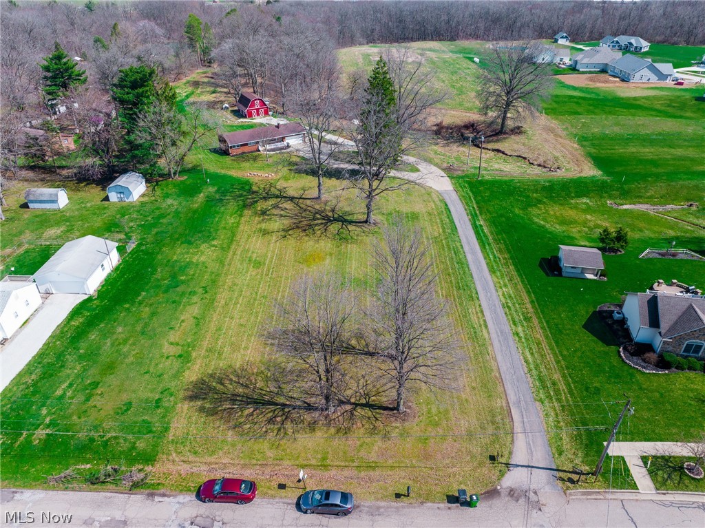 Online Auction begins ending June 8th. Bring your vision to life on this beautiful 0.55-acre building lot located within the city limits of Rittman. Offering a level, ready-to-build setting and access to public utilities, this property is an ideal canvas for your custom dream home. Enjoy the convenience of city amenities while being tucked into a quiet, established neighborhood—perfect for those seeking both comfort and community. Opportunities like this are becoming increasingly rare, making this a lot you won’t want to miss.
An added bonus: the home and 10 acres directly behind this parcel are also available for purchase, offering potential for expanded space or investment possibilities.  Utilities available include electricity, natural gas (connected), public sewer, and water.