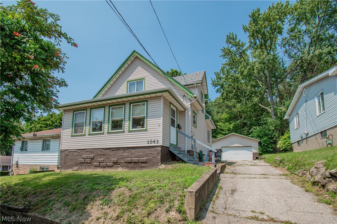 Welcome home to this spacious Colonial located in Akron! Step inside to an inviting open foyer showcasing the staircase and leading into an oversized living room, a formal dining room with built-in shelving, and a generously sized kitchen. The first floor also features a bedroom with an attached full bathroom, offering flexibility for guests, an office, or convenient main-level living. Upstairs, you'll find three additional bedrooms and another full bathroom. The basement provides plenty of extra storage, while the two-car garage adds everyday convenience. Relax and enjoy the enclosed front patio, perfect for morning coffee or unwinding at the end of the day. Schedule your private showing today!