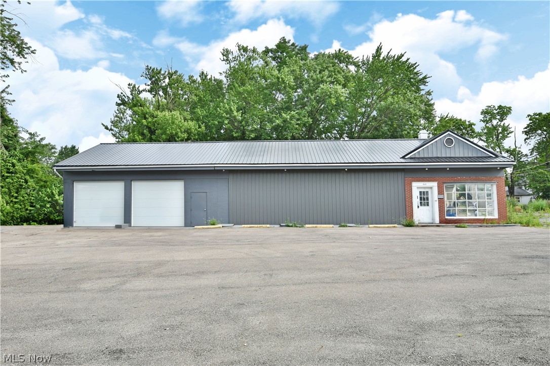 Don’t miss your chance at this fantastic opportunity, located on an advantageous, high-traffic location in the up-and-coming downtown Warren area. With revitalization projects in full swing, this substantial property with its long running office and garage/warehouse space is in a prime position to take advantage of future growth. Once configured as an automotive shop, the stylish gray building has been converted into an open office and garage/warehouse space, still keeping its window lined lobby, complete with brick accent work and additional pent roof. Industrial grade lighting can be found throughout with concrete floors underneath. Overhead heating is ducted neatly over the potential shop bays or office area as needed. Multiple secure entryways allow for four-sided access and past garage lift assemblies remain in place. The garage/warehouse is 31' x 27' and offers two new 9' x 11' garage doors. An additional bonus room allows for an employee lunchroom and additional storage along wi