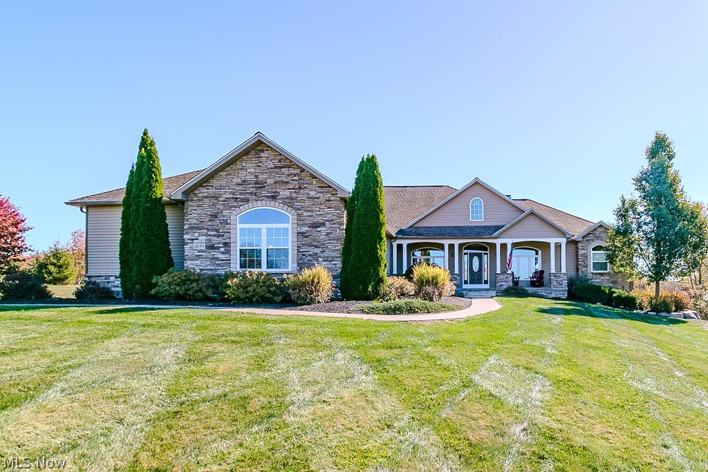 Beautiful custom-built ranch home situated on 5+ wooded acres. This expansive property offers over 6,400 finished sq ft of living space, featuring 4 bedrooms, an in-law suite, and a full walk-out basement with a covered patio. The lower level includes an exercise room with a custom sauna and a wet bar—perfect for entertaining.
The main level boasts an open floor plan, a spacious eat-in kitchen, great room and family room each with stone wood-burning fireplaces, a large first-floor laundry room, and a mudroom with built-in bench and cabinetry. The primary suite includes a newly remodeled bath, and new carpet has been installed throughout.

Additional highlights include a heated oversized 3-car garage, garden area with shed, and a whole-house generator. This home is ideal for a growing or multi-generational family, offering both space and comfort. Conveniently located near Notre Dame Cathedral Latin, Historic Fowlers Mill, Alpine Valley, Geauga Parks, UH Geauga Hospital, and just minutes from shopping, dining, and 30 miles east of Downtown Cleveland. Agent-owned property.