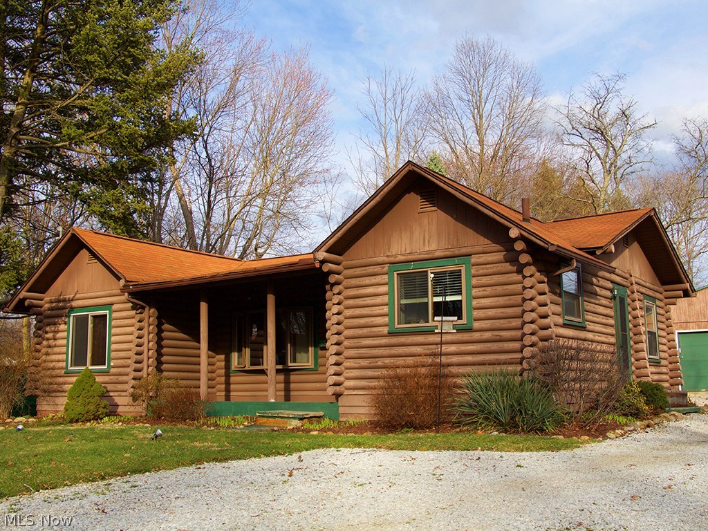 One of a kind! This charming rustic log cabin is located in the heart of Stow.  You can feel the coziness the rich warm wood offers as it glistens from the hot embers burning in the magnificent stone fireplace.  The living room boasts vaulted ceilings and gorgeous wood flooring.  An updated kitchen includes white cabinetry, stainless steel appliances and slate flooring.  The first-floor full bath has been update and features a pedestal sink.  There are three bedrooms that complete the first level. Moving down to the impressive lower level, you will find a spacious family room that includes a butler’s pantry that offers room for a wine refrigerator. The full bath has been remodeled to perfection.  There is still loads of unfinished space in the basement for storage or possibly a room addition.  Situated on a large lot, you can enjoy the outdoors on the patio or relaxing on the front porch.  The oversized 2car garage lends plenty of space for your outdoor extras.  3559 Marcella Ave is a
