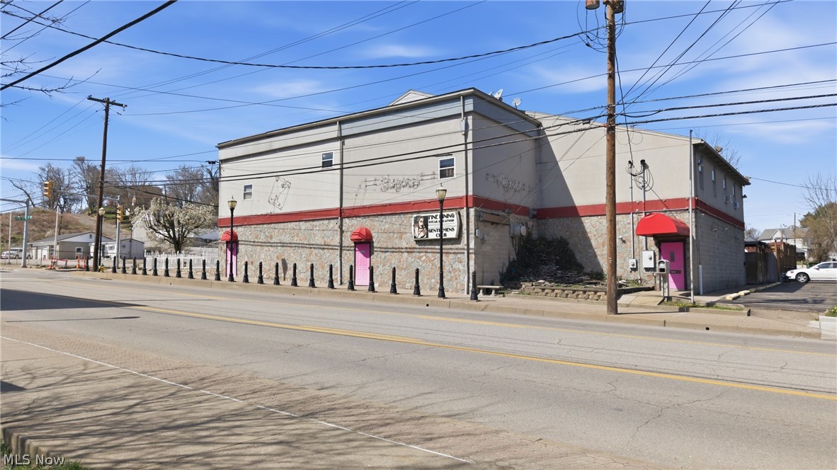 High-Traffic Investment Opportunity in Parkersburg, WV – Six (6) Parcels Located on high-visibility Seventh Street in Parkersburg, West Virginia, this rare commercial property spans seven parcels in one of the city’s most trafficked areas. Formerly operating as a nightclub, the main structure includes a commercial kitchen, two full bars, public restrooms, and a dressing area—ideal for continued entertainment use or future redevelopment. The property also includes a variety of income-generating residential units, all with owner-paid utilities, as well as ample parking and an oversized three-car garage with garage apartments. Residential breakdown includes: Attached Owners Apartment: Elevator access, two bedrooms, one full bath, open-concept kitchen/living area, plus two sleeping rooms with a shared bathroom (each sleeping room rents for $500/month). Two Garage Apartments (above oversized 3-car garage): One 2-bedroom and one 1-bedroom unit, each renting for $600/month. Two Additional Units: Located near the private courtyard, renting for $700/month and $600/month respectively. Estimated Gross Monthly Rental Income: $4,500 (Based on full occupancy and current rental rates) With multiple income streams, strong commercial potential, and a prime location, this versatile property is an outstanding investment opportunity in the heart of Parkersburg.