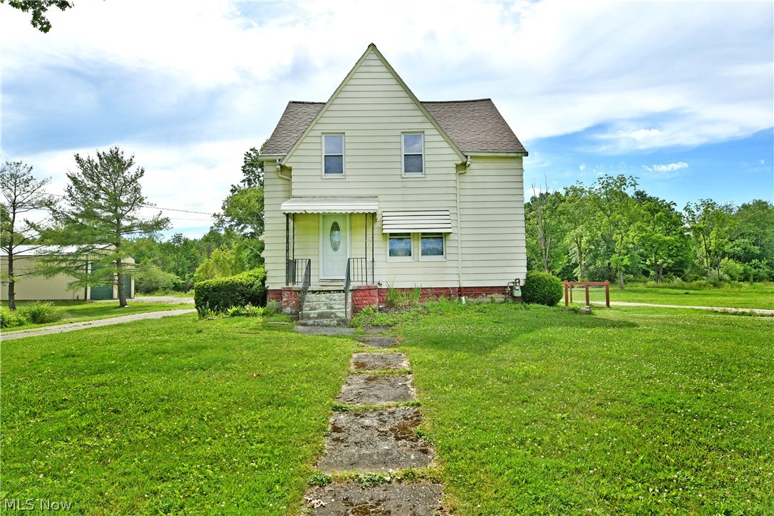 Have you been searching for a taste of farmhouse-style living? How about one with a little land to call your own? Better yet, what if it’s move-in ready and offers plenty of garage space for your toys, equipment, or even a large RV? Don’t worry, this hot-to-market Champion home has it all! Set on over 10 acres, this exciting property offers room to grow and endless possibilities. Traditional styling creates a welcoming first impression with a covered front porch, fenced backyard, and convenient side entrance. Meanwhile, the wraparound driveway passes a large storage shed, garden area, and pond before arriving at the show-stopping 40x30 steel outbuilding. Complete with 6-inch concrete floors, water and electric service, soaring 16-foot ceilings, and oversized overhead doors, the space is ready for everything from RV storage and equipment parking to a dream workshop. Inside, a welcoming living room showcases gorgeous hardwood flooring, matching trim, and solid wood doors that add to the home's farmhouse charm. Around the corner, the central dining area features whimsical mason jar lighting and built-in shelving, creating the perfect space to gather and display your favorite décor. The darling kitchen shines with stone-look countertops, a tiled backsplash, stainless steel appliances, and a dual-window sink that fills the space with natural light. Completing the main level, a first-floor bedroom is joined by a tastefully updated full bath featuring a unique circular shower. Upstairs, four impressively sized bedrooms offer comfortable, carpeted surroundings and abundant natural light. Additional storage space is tucked away nearby, while a beautifully updated full bath showcases lavish tile work across both the flooring and shower surround. Laundry and additional storage are conveniently located in the basement. Updates include: roof 2016, water heater 2024, carpet 2026, electric box 2020, septic 2020 w/ passing inspection 2026, and so much more! Plus 1 yr home warranty!