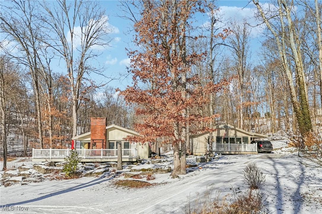 One-of-a-kind LAKEFRONT COTTAGE retreat with GUEST HOUSE on 5.85 wooded acres. Discover a rare opportunity to own a serene lake property in Amish country, featuring a charming-style lake house, fully equipped guest house, a private pond, and nearly six acres of wooded privacy. The main 918 sq. ft. cottage lake house, comfortable sleeps 3-5 is designed to immerse you in nature with stunning walls of glass that frame peaceful lake and woodland views. High-quality Amish construction and thoughtful upgrades include wrap around Trex decking, wood siding, a metal roof, gutter guards, a whole-house generator, 200 amp electrical service, gas furnace with central air and comfort-heated laminate floors throughout. Premium Pella windows and doors enhance both efficiency and style with blinds between the glass. The kitchen is well appointed with a new $5,000 Kitchen Aide gas range with an electric oven, refrigerator, dishwasher and trash compactor- perfect for everyday living or entertaining. Breath taking views as deer gather just outside the kitchen window! Beautiful landscaping surrounds both homes creating a true cottage retreat. The GUEST HOUSE is 758 Sq Ft and sleeps 4-6, provides exceptional comfort and privacy. Features include comfort-heated laminate flooring, a full wall of glass, Trex decking, metal roof, gutter guards, Pella windows and doors with blinds between the glass, electric heat and A/C, a small kitchenette, laundry room, carport, storage, dog kennel all idea for hosting family or earning income through an AirBnB. A NEW24x28 GARAGE, finished with knotty pine on the inside offer endless possibilities as a workshop, recreational space or the ultimate man cave. This UNIQUE property offers tranquility, flexibility and craftsmanship rarely found together. Perfect as a full time residence, weekend get-a-away or multigenerational retreat! Please take written directions with you as you may loose service depending on your carrier.