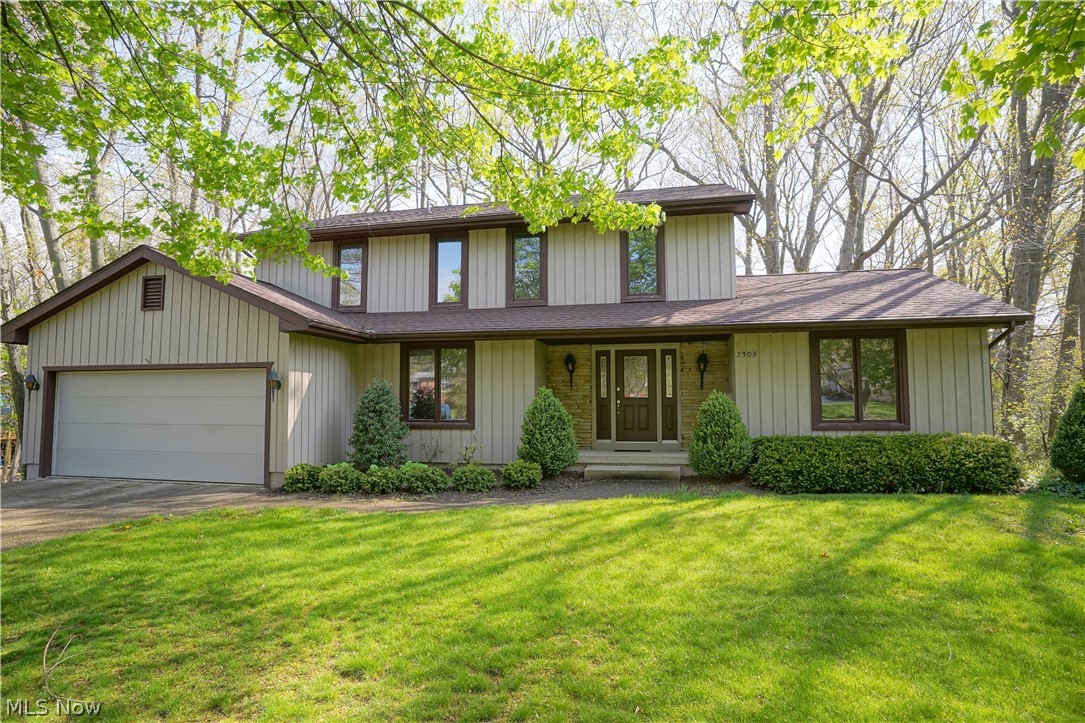 Large 4-bedroom Colonial with spectacular views of Sand Run Park. This original-owner home has large formal living room with crown molding which has sliding doors to brand-new, 2nd story deck and French doors to fireplaced (brick) family room.  Large, applianced kitchen includes extra breakfast room with wall of built-ins and bay window facing the park.  There's also a formal dining room with crown molding and chair rail.  Also included on the first floor is a half bath, laundry room with utility tub and entry to attached 2-car garage w/electric and hot/cold water.  Upstairs is master bedroom with it's own deck, walk-in closet with vanity and master bathroom.  There's three more bedrooms, two with double closets and one with shelving, and the main bathroom which has "separate" 2nd vanity/sink.  Lower level includes "L" shaped rec room or could be two separate rooms, workshop area, utility/storage room with built-in shelves, additional storage "room" and half bath.  Basement walk-out le