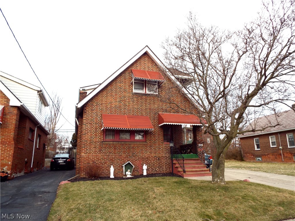 This meticulously maintained brick home was built and owned by one family since the 1920s! Find this brick home on a quiet street in the heart of Collinwood, steps from schools, shopping, recreation, & entertainment in the Waterloo Arts District. Enjoy spring from the front porch as you watch the magnolia tree blossom. Inside you will find a lovely living room with mosaic tile detail. Original doors, leaded glass built in shelving, and tall ceilings with original woodwork show the care and pride put into this home. The formal dining room is flooded with light and the perfect size for entertaining. The large kitchen offers tons of potential with original woodwork in excellent condition. Off the kitchen are two first floor bedrooms and a full bath with original claw foot tub. This home has always been used as a one family, but it could be easily converted into a two family. Upstairs there is another large space for a kitchen, a large living room area (or master bedroom) with a covered ba