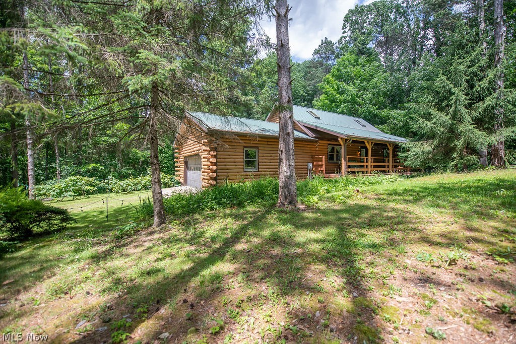Custom built log home by Pariso Log Homes, located in TAPPAN HIGHLANDS. This rustic log home is on a 2.67 acre lot, on private ground at TAPPAN LAKE. The kitchen cabinetry is shaker style, with newer laminate counter tops(2025), an island that seats 3 .The living room has a wood burner insert with stone wall. Around the corner is a sunroom/dining room with redwood plank flooring all with cathedral ceilings and  2 bedrooms and a full bath completing the first floor. The second level is the private master bedroom with wood floors and a skylight. Lower level has the laundry, a rec room and a full  bath, which leads out to a private patio over looking the secluded wooded acreage. The front porch stretches around the side of the home, great place for those rocking chairs. The house and deck were stained in 2025, water heater and heat pump new in 2023. New wider spouting and gutter guards were added in 2025. All appliances, including W&D are included in the sale, but are not warranted by seller. Seller is receiving a homestead credit of $368 a yr. There is dock space available down the road for this property. You would have to apply thru MWCD. Seller is retaining mineral rights. If you are looking for a secluded, quiet, and peaceful setting at Tappan Lake, look no more, this  is it!!
