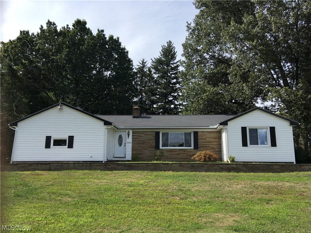 Spacious Painesville ranch on a huge corner lot close to everything with a driveway on Mentor Ave and Harmon Ave. 4 bedroom ranch with 3 bedrooms on main floor with the 4th bedroom on the lower level away from the rest of the house. Completely updated eat-in kitchen with granite countertops that looks into the vaulted ceiling sunroom /family area. Kitchen eating area goes right into the big living room with a fireplace. Bathrooms updated with newer vanities, sinks, flooring etc. including the full bath in the lower level. There are beautiful real wooded walls in the lower level recreation room, where the family can relax or play. The laundry room has a full set of kitchen cabinets for storage or whatever. Close to shopping and the freeways. Come check this one out before it is too late!