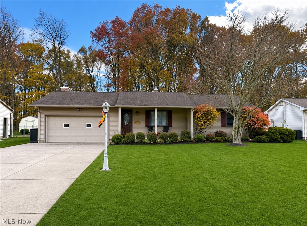Nestled in a quiet, highly sought-after neighborhood within the Austintown Local School District, this beautifully maintained ranch offers the perfect blend of comfort, updates, and privacy — all just minutes from shopping, dining, and local parks.

Step onto the charming Nature Stone-covered front porch and into a spacious living room filled with warmth and natural light. The home features three bedrooms with newly refinished hardwood floors and brand-new Renewal by Andersen windows installed in 2025. The fully remodeled bathroom showcases elegant Italian porcelain tile and a modern fiberglass surround tub completed in 2019.

The updated kitchen comes complete with newer appliances and opens seamlessly into a generous dining area and cozy family room featuring a fireplace — ideal for entertaining or relaxing evenings at home. Just off the family room, enjoy a stunning 220 sq. ft. all-season sunroom with beautiful cedar walls and ceilings overlooking the gorgeous fenced backyard that backs up to a peaceful greenbelt for added privacy. A storage shed adds extra convenience.

The spotless basement offers newer glass block windows and vents, a General Ionics whole-house water softener, newer hot water tank, and updated electrical box. The roof is approximately 10 years old. Added peace of mind comes with a Choice Home Warranty in place through October, covering heating, cooling, appliances, electrical, and plumbing.

This move-in ready home is truly a must-see!