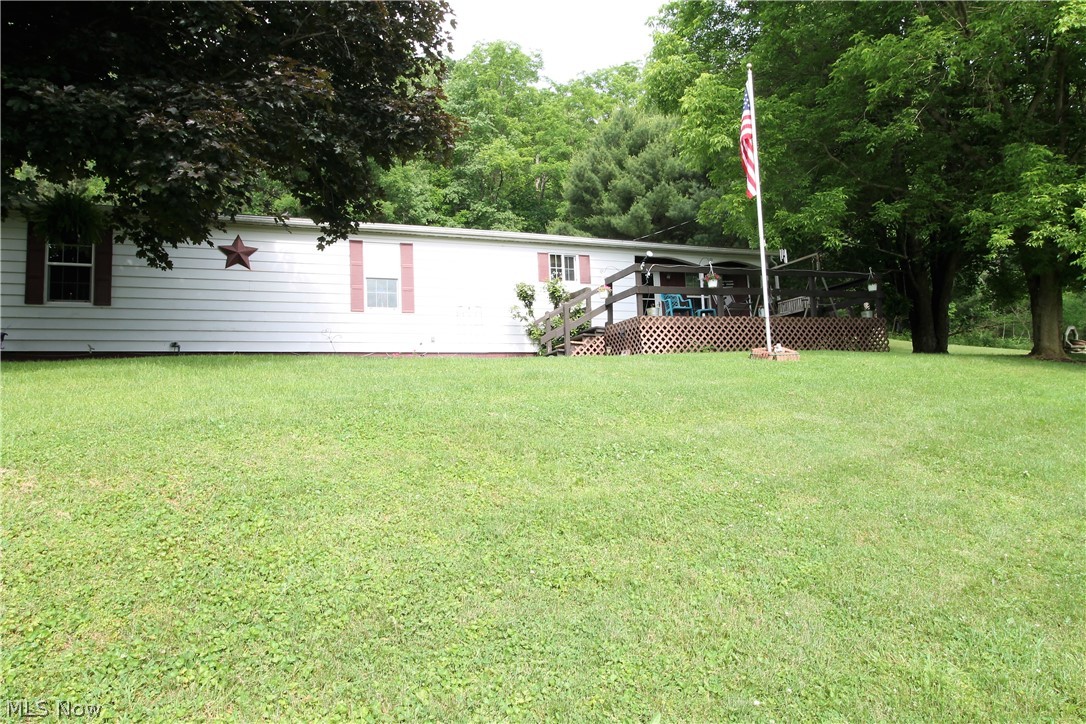 Picturesque privacy on this 3.26 acres offering the feeling of being secluded but just minutes from Tappan Lake. This home offers a deck in the front where you can sit out and enjoy the stunning views. There are three bedrooms, two full baths, living room with wood burner which can heat the home, dining room, large kitchen. The kitchen has a cooktop, bar sitting, wall oven, refrigerator and all open to the dining room. The backyard you will find a patio leading from the home so you can sit out and enjoy the fabulous views, or entertain, two car carport, two sheds that have electric. New hot water tank (2020).  Nothing better than a postcard setting!