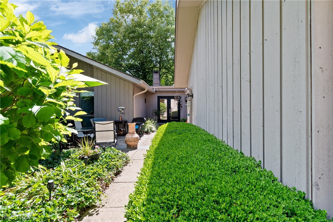 Welcome to an exceptional opportunity in Walden, one of Aurora's most prestigious and sought-after communities. Perfectly positioned as a private end-unit surrounded by mature trees and beautiful landscaping, this stunning ranch-style residence offers the convenience of one-floor living combined with the elegance, comfort, and lifestyle today's buyers desire. Offering over 2,000 square feet, this spacious 3-bedroom, 2-bath home welcomes you with a charming front patio, professionally landscaped garden beds, and an inviting private entrance. Inside, natural light pours through a dramatic wall of windows, creating a bright and airy atmosphere throughout the open-concept floor plan. The impressive great room is the heart of the home, featuring a striking masonry brick gas fireplace with a custom wood mantel, wet bar, and seamless flow for entertaining. The adjacent formal dining room is enhanced by an elegant chandelier, easy access to the deck and patio, creating the perfect setting for indoor-outdoor gatherings. The bright galley-style kitchen showcases timeless white shaker cabinetry and full appliances, and a cozy eat-in dining area with a sliding glass door overlooking the beautifully landscaped grounds. Retreat to the oversized owner's suite featuring its own brick fireplace, large walk-in closet, and private ensuite bath with ceramic tile flooring and tiled shower. Two additional bedrooms, private reading nooks, flexible office space, and abundant storage provide versatility for a variety of lifestyles. Recent improvements include a new roof (2025), furnace (2023), hot water tank (2023), laminate flooring, newer carpeting, updated mantel, bluestone front patio, garden beds, and rear stone steps. Enjoy the unparalleled Walden lifestyle with nearby golf, dining, shopping, medical facilities, recreation, and convenient commuter access. Rarely does a home offering this combination of privacy, luxury, convenience, and location become available. Welcome home!