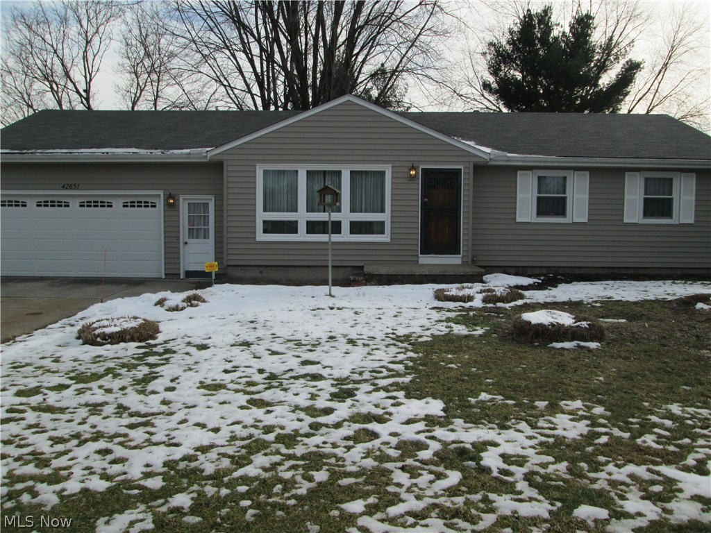 Exceptional ranch home in near mint condition, and almost half acre lot.  Nice big Kitchen with nice flooring and newer Whirlpool Gold stainless appliances, including cook top stove, wall oven, and refrigerator.  Spacious 18x13 living room with hard wood floors.  Newer windows.  3 bedrooms with spacious closets, and 1.5 baths on main floor.  Gas forced air heat and central air '01.  Hardwood floors throughout.  Newer roof, windows, and doors, 8-10yrs old.  Top of the line Steel siding.  Electric updates less than 10 yrs. Furnace and air conditioning '06. Located in Elyria Twp.  Stock brand security system installed.  Sliding glass door off kitchen leads out to 119x12, covered patio, screened in for year round use.  Nice big paved driveway fits 6 cars easily.   2.5 car, over sized garage with speckled painted floor, newer garage door, and floor drain.  Full unfinished basement with speckled painted floor ($5,000). New septic in '15 ($10,000).  This is a rare find.  Exceptional quality t