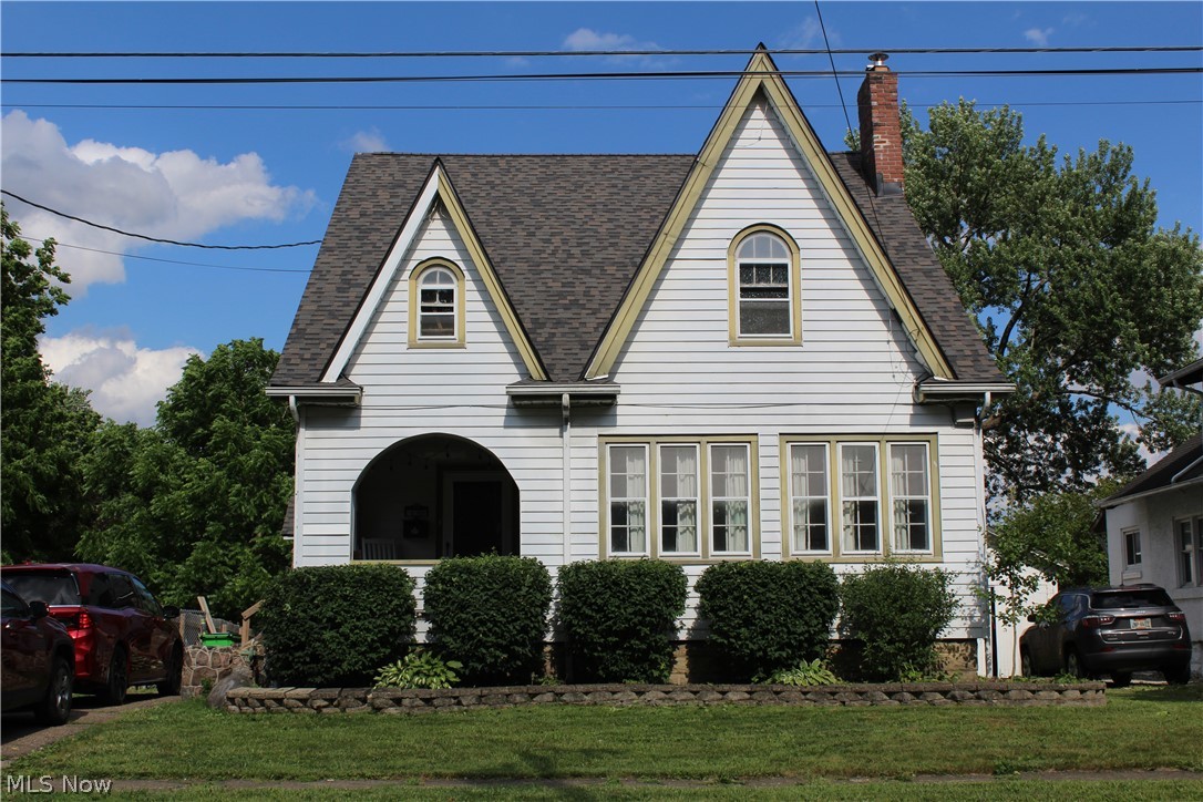 Charm and character abound in this classic Colonial featuring beautiful original woodwork and hardwood floors throughout the main level. The inviting family room offers a cozy fireplace, while the formal dining room showcases built-in cabinetry that adds both style and functionality. A bright front sunroom provides the perfect space to relax and enjoy natural light.  The kitchen features new tile flooring and several recent updates. Upstairs, you'll find three spacious bedrooms, each with large closets, along with a newly updated full bath. A convenient half bath is located on the main floor. The finished third floor adds valuable additional living space, ideal for a home office, playroom, or bonus room.  Outside, enjoy the privacy of a fenced backyard, perfect for entertaining, pets, or outdoor activities.  (Playset does not stay) Roof replaced January 2025, Hot water heater January 2024. Kitchen appliances stay.