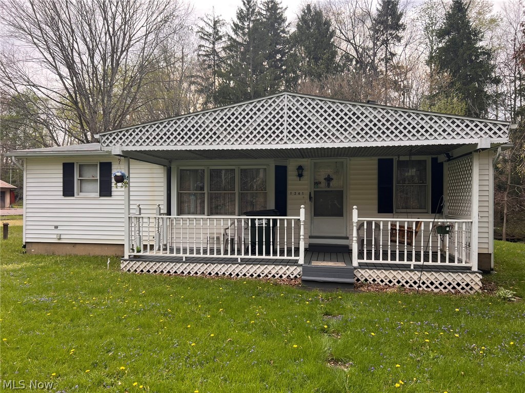 Welcome to 1241 Bison St. This two bedroom, two bathroom home sits on just over an acre of land. The lot is divided into two sections, the front portion offers lawn space, complete with fenced in dog yard. The back section of the lot, which is separated by a stream flowing through the yard, features a wooded hillside which has endless possibilities for the nature lover. The spacious two car garage has a mechanics pit. The interior of the home, features built-in drawers in the dining room and bedroom, along with a bult-in eat in bar. The family room offers a connection and chimney for a wood burning stove to be placed for winter time heating. The unfinished basement has updated HVAC and water heater. This property is connected to city water, but also has option to be hooked up to a well. Whether you are looking for the retro appeal or a home ready to be updated with a modern touch, 1241 Bison is ready for you.