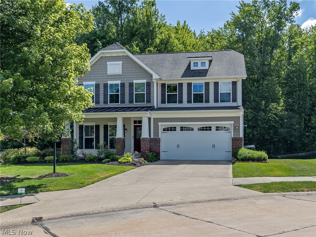 Welcome to this lovely 3-bedroom, 2.5-bath Colonial offering 2,644 sq.ft of beautifully designed living space, perfectly situated on a quiet cul-de-sac street in the Landings at Timberlake community in Olmsted Township. From the moment you arrive, you'll appreciate the charming curb appeal featuring a welcoming covered front porch, carriage-style garage door, lush landscaping, & a peaceful wooded backdrop. Step inside to an inviting foyer that opens to a versatile flex room ideal as a home office, formal dining room, playroom, or additional living space. The impressive 2 story great room serves as the heart of the home, w/ a dramatic floor-to-ceiling stone fireplace & a wall of windows that fill the space w/ natural light & picturesque views of the private backyard. The spacious eat-in kitchen is designed for both everyday living & entertaining, featuring a large center island w/ seating, granite counters, warm wood cabinetry, abundant storage, & all appliances included. Just off the kitchen, the vaulted sunroom provides the perfect place to relax & leads to an expansive tiered composite deck overlooking the private tree lined backyard. A convenient first-floor laundry room w/ newer washer & dryer, along w/ a powder room, completes the main level. Upstairs, you'll find 3 generously sized bedrooms &  2 full baths, including a spacious owner's suite w/ vaulted ceilings, a walk-in closet, & a private en-suite bath featuring a soaking tub, tiled walk-in shower, & double-sink vanity. The full basement offers excellent storage space & endless potential for future finishing to suit your needs. Additional features include a whole-house Generac generator, updated security system, & new toilets in all bathrooms. Residents of the Landings at Timberlake enjoy community amenities including a swimming pool, clubhouse & playground. Combining spacious living, modern conveniences, and a great location, this beautiful home is one you won't want to miss!