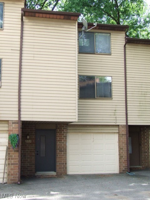 Wonderful condo unit consisting of large living/dining room combo with 2 exposed brick walls, dark wood beams in ceiling with track lighting, sliders to newer deck/balcony overlooking woods and pond.  Fully equipped kitchen was updated in 2009 with granite countertops, whitewashed maple cabinets, deep sink, and includes refrigerator, stove, dishwasher and microwave.  Up the spiral staircase is the LOFT bedroom with vaulted ceiling and beam, ceiling fan, two doube closets with more storage on top, and more views of the woods and pond.  Full bath with some extra storage and uniqe "sunken" tub/shower.  First floor has foyer area, laundry room with washer, dryer, utility sink, built-in cabinets and entry to attached 1-car, deep garage with opener and shelves. Living room has gas line that could be used for gas fireplace.  Updates include kitchen 2009, roof 2011, hot water tank 2021, furnace 2022, deck 2022. Association allows pets and leasing.  Home warranty included.