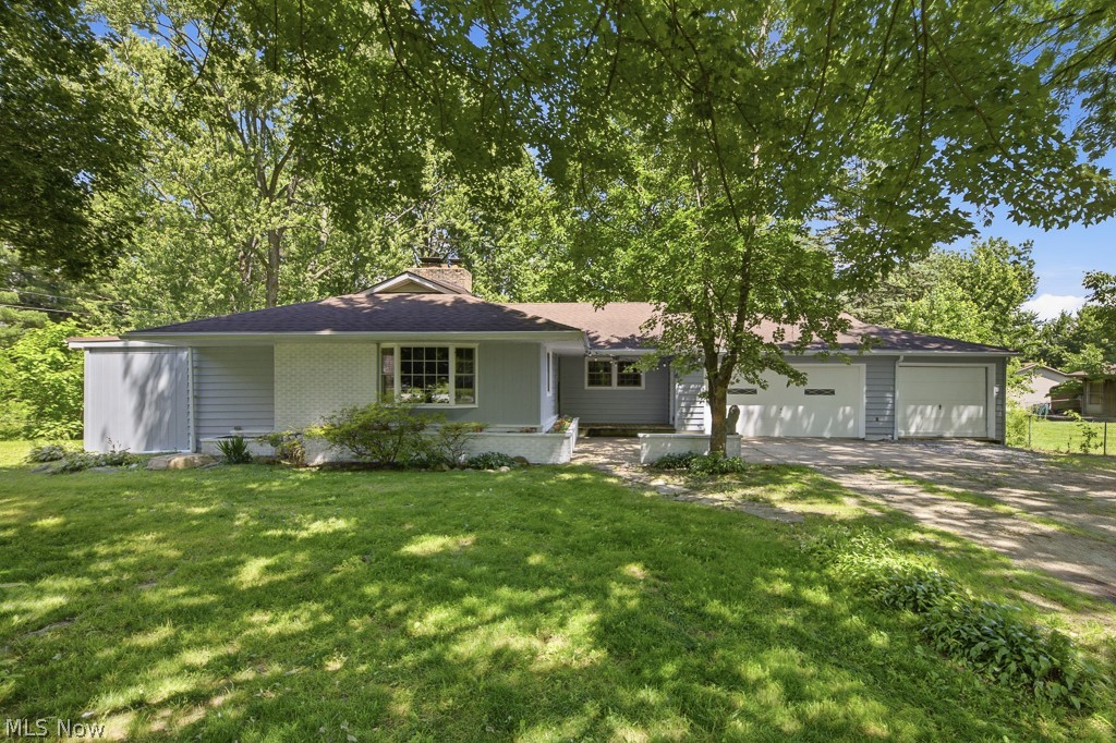 Welcome home to this beautifully maintained ranch nestled on nearly an acre in the highly sought-after Green Local School District! From the moment you step inside, you'll appreciate the spacious open-concept design where the living room, dining area, and chef's kitchen come together to create the perfect space for everyday living and effortless entertaining.

The heart of the home is the impressive chef's kitchen, featuring abundant cabinetry, generous counter space, double wall ovens, a gas cooktop, and a large peninsula overlooking the main living area. Anchoring the space is a stunning brick fireplace that adds warmth and character while creating the perfect gathering place for family and friends.

This home offers three comfortable bedrooms, including a spacious primary suite complete with its own private ensuite bath. An additional bonus room just off the kitchen offers endless possibilities. Whether you're dreaming of a home office, playroom, hobby space, workout room, or even a potential fourth bedroom, this flexible space is ready to fit your lifestyle.

The massive lower level is a blank canvas waiting for your personal touch. Create the recreation room, home theater, workshop, gym, or entertaining space you've always envisioned.

Need garage space? This property delivers! With an incredible amount of garage and storage space, there's plenty of room for vehicles, hobbies, tools, and all your outdoor toys.

Situated on nearly an acre, you'll enjoy room to spread out, entertain, garden, or simply relax and enjoy the peaceful surroundings, all while being conveniently located near shopping, dining, parks, and major highways.

This is more than a house... it's an opportunity to create the next chapter of your story. Welcome home!