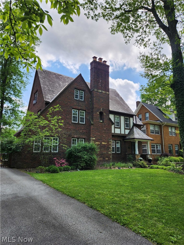 Meticulously maintained 3763 sq ft 5 bedroom, 5 bathroom Tudor in Cleveland Heights historic Grant Deming District. This beautiful home is in a neighborhood near libraries, theaters, grocery stores and restaurants. Renovated from top to bottom, inside & out! Multiple improvements include newer vinyl windows, updated plumbing and electrical systems, refinished hardwood flooring, recent interior and exterior painting throughout, original doors and crystal doorknobs, spacious living room with beautiful marble fireplace, sunroom, dining room, chef’s white kitchen with granite countertops, built in china cabinet, new induction stove, new refrigerator and dishwasher, luxury vinyl flooring, half bath; partially finished basement with fireplace, tile floor, half bath, newer refrigerator; laundry with new dryer, newer hot water heater, forced air gas furnace, AC. Second level has 3 bedrooms and 2 full baths including a luxury primary suite with completely updated bathroom with glass shower, bidet toilet and LVF, and large closet and sitting room. Finished third floor has two additional large bedrooms and another full bathroom with new tub shower and new LVF. Outside there are new K Guard gutters with heat tape, updated slate roof, ceramic lined sewer drain system, basement B dry system. There is an attached 2 car garage with new doors. The sunroom leads to side porch and spacious backyard with a stone outdoor kitchen and patio area, with beautiful perennial gardens, a small Japanese garden, raised beds for vegetable gardening in the private fenced backyard.
