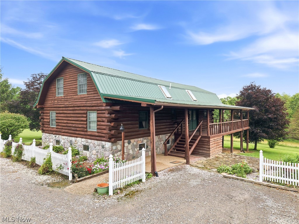 One-Owner Custom Log Home on 2.77 Scenic Acres!  Nestled in a peaceful country setting with gorgeous panoramic views, this stunning Red Pine log home, crafted from logs sourced in Northern Pennsylvania, offers the perfect blend of rustic charm and modern comfort. Relax and take in the beauty of the countryside from the expansive wrap-around deck that surrounds this exceptional property.  The story of this unique home began in 1997 with the construction of a 2-bedroom, 1-bath basement home. In 2005, the impressive log home was completed, creating a spacious retreat filled with warmth and character.  The main level features a welcoming kitchen with a breakfast bar, maple cabinets, and appliances, opening to a dining room with direct access to the deck. The cozy living room showcases a wood burner, creating the perfect gathering space. Two bedrooms and a full bath complete the first floor.  Upstairs, you’ll find a private master suite area featuring a bedroom, half bath, and loft overlooking the living space below.  The walk-out lower level offers incredible flexibility with two additional bedrooms, a full bath, family room, kitchenette, laundry area, and ample storage—ideal for guests, extended family, or multi-generational living.  A 3-car heated garage provides plenty of space for vehicles, hobbies, and equipment.  Set on 2.77 beautiful acres, this one-owner property is a rare opportunity to own a truly special country retreat where craftsmanship, comfort, and breathtaking views come together.