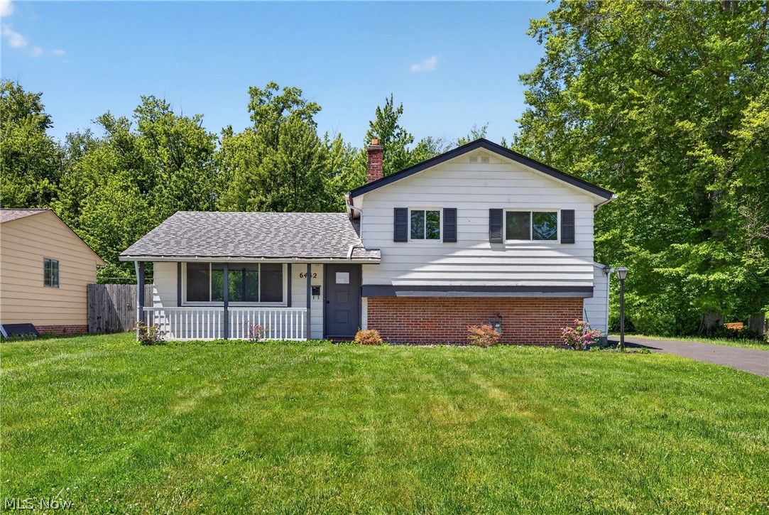 Dreaming of a 4-car garage? Welcome to 6452 Brooks Blvd — where space, style, and privacy come together beautifully. This impressive 1,056 sq ft garage with a new 2026 roof offers endless room for cars, toys, hobbies, storage, or a workshop setup you’ve always wanted. Inside, the 1,583 sq ft home feels bright and open with soaring vaulted ceilings and luxury vinyl flooring flowing seamlessly through the living room, dining area, and sunroom. The beautifully updated white kitchen has with new cabinetry, fixtures, and lighting open for dining and entertaining. The lower-level family room adds valuable additional living space, ideal for movie nights, gatherings, or a cozy retreat. The fully renovated main bath offers clean, stylish finishes, while the added lower-level half bath brings extra convenience. Step outside to enjoy a fully fenced backyard with a peaceful wooded tree line creating exceptional privacy and tranquility. The exterior trim is freshly painted 2026 and the driveway has been resurfaced. The seller is offering a one year home warranty for peace of mind.