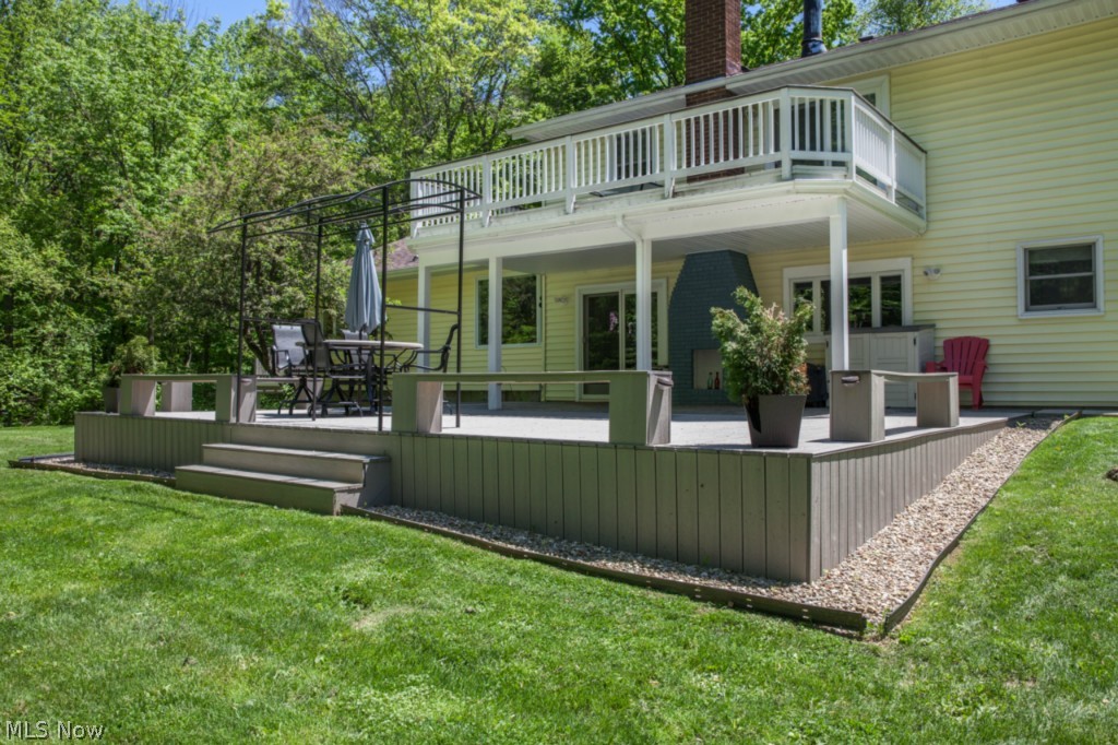 LOOK INSIDE and see the amazing features found in this completely remodeled home on 4.68 wooded & private acres, additional 2 car outbuilding provides workshop or studio space, 4 car total garage capacity. Radiant Heated travertine tile floors are featured in dream kitchen, along w/ maple cabinets, dual oven & cooktop, glass door pantry, huge island with seating & vegetable sink, SS appliances stay, Kitchen w/ access to back patio & outdoor fireplace. Vaulted 26x26 great room includes corner heatilator wood burner which cuts down heating costs, Pergo xp floor ('14),  plenty of space for dining, sitting & media areas, & leads to trex deck w/ stunning panoramic view. Owners suite features raised hearth Gas Fireplace, walk-in closet w/ built in organization & Sun Deck. Luxurious Owners private bath features oversized porcelain tiled shower & floor, double vanity, & effervescent (air jetted) tub. Two additional generously sized bedrooms measure 16x10. Guest Bath features large tiled shower
