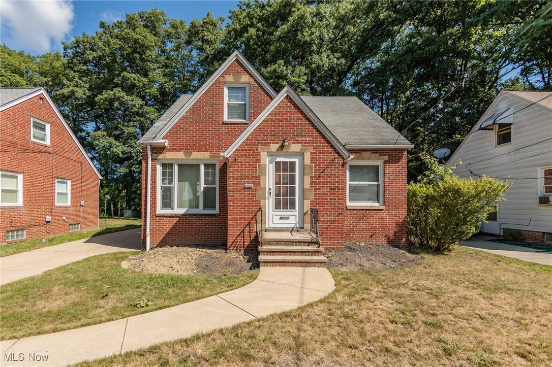Welcome to 4521 Emerson Rd, a charming 4 bedroom, brick Cape Cod, situated on a lovely property with private, wooded, creek views in South Euclid! Inside the large & bright living room showcases wood floors and decorative fireplace. The spacious eat-in kitchen offers wood cabinetry, plenty of prep space, dining area & included appliances. The dining area has access out to the desirable backyard w/ patio & oversized 2 car garage! Back inside, the main level provides 2 comfortable bedrooms & a full bathroom. Upstairs you will find the Owner's Suite with convenient 1/2 Bath & Office/4th bedroom option! More living space is found in the partially finished, waterproofed basement with a sump pump, recreation room, bonus room, ample storage and laundry area! Other great features and improvements include: Sewer and Storm p-traps replaced with cleanouts(2024);Water heater (2024);Stove and dishwasher (2023);Oak trees trimmed(2022) plus a 1 year home warranty! Call today for a private showing to see how you can make this home your very own!