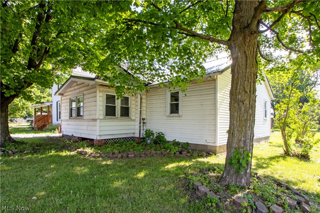 Move right in and enjoy the many updates this well-maintained home has to offer! The updated kitchen provides a functional and inviting space for everyday living. Additional improvements include a newer metal roof, replacement windows, vinyl siding, a 2022 water heater, and a 2018 well pump. Convenient first-floor laundry adds to the home's practicality. Outside, you'll find exceptional garage and storage space with a detached 2-car garage featuring an opener, concrete floor, electric service, and additional storage area. A second 1.5-car red garage with a concrete floor provides even more room for vehicles, hobbies, or equipment. Don't miss this opportunity to own a property that combines updates, functionality, and ample storage.
