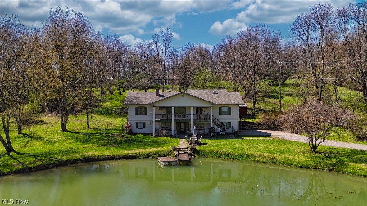 Welcome to your private country retreat on over 5.5 picturesque acres in St. Clair Township, located within the Beaver Local School District and just minutes from the Pennsylvania and West Virginia state line. This exceptional property offers a rare combination of space, functionality, and scenic beauty, complete with a stocked koi pond, expansive outbuildings, and endless possibilities. The main level of the home features three bedrooms and two full bathrooms, along with a spacious living room highlighted by a cozy fireplace. A formal dining room offers its own fireplace and built-in cabinetry, creating the perfect setting for gatherings. The kitchen includes a pantry and provides access to two covered rear decks, ideal for relaxing or entertaining. Just off the living room, a large covered front porch overlooks the serene pond, offering a peaceful place to unwind. Upstairs, you’ll find two additional bedrooms, including a pass-through bedroom and extra storage space. The fully finished walkout basement expands the living space with a family room featuring a fireplace, a full bathroom, laundry room, utility room with workshop area, and an attached two-car garage. Step outside to a covered patio at ground level, perfectly positioned near the pond for easy outdoor enjoyment. Outbuildings abound, including a detached wood shop or playhouse located just behind the home, a large red barn recently stained in 2024, and a detached garage adjacent to the barn—ideal for hobbies, storage, or equipment. A standout feature of this property is the expansive dog kennel facility, offering 26 runs, oil heat, wall air conditioning units, a cat room, grooming room, half bathroom, and its own separate 100-amp electrical service—perfect for breeders, trainers, or animal enthusiasts. This one-of-a-kind property offers a unique opportunity to enjoy country living with incredible versatility—whether for a hobby farm, business venture, or private estate.