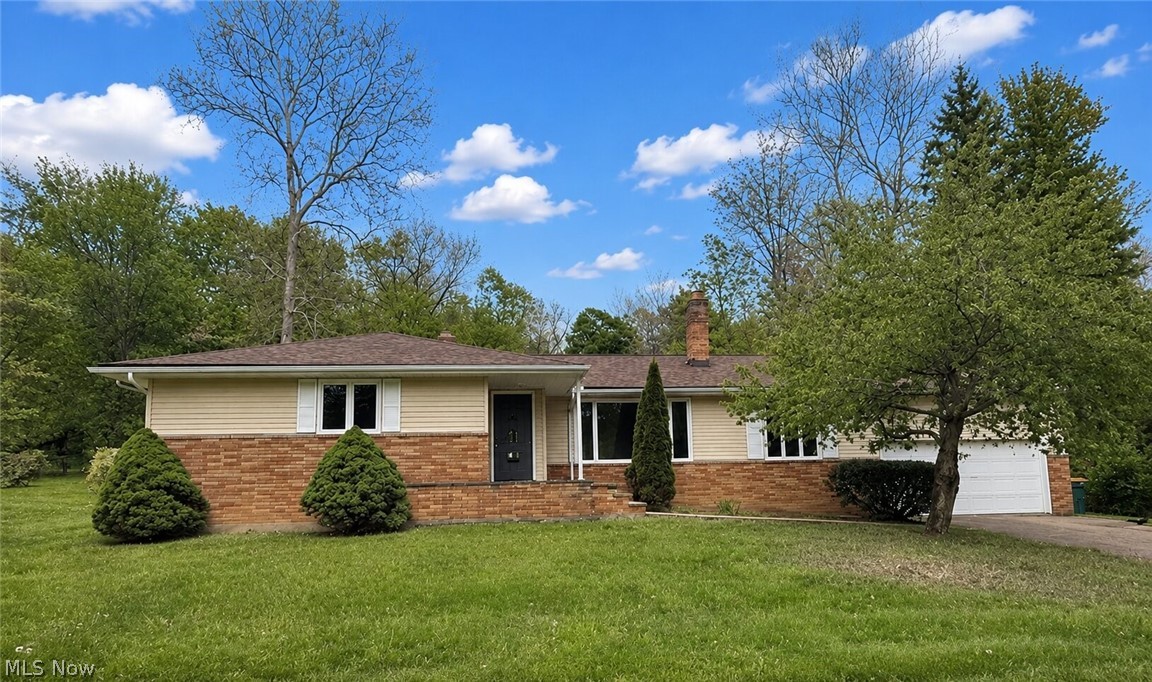 Completely renovated from top to bottom, this stunning Kirtland ranch offers the perfect combination of modern updates, peaceful wooded surroundings, and effortless one-floor living! Nestled on a serene and private acre on sought-after Hickory Hill Dr, this move-in-ready home showcases incredible mid-century modern character blended seamlessly with today’s designer finishes.

Step inside to an airy open-concept layout featuring a gorgeous double-sided wood-burning fireplace shared between the spacious living and family rooms, creating the perfect atmosphere for relaxing or entertaining. The beautifully updated white kitchen is the heart of the home, complete with quartz countertops, decorative backsplash, center island, stainless steel appliances, and open dining space ideal for gatherings large or small.

Designed for convenient first-floor living, the home offers 3 main-level bedrooms, including a private primary suite with ensuite bath, plus an additional full bath down the hall. Even the laundry area is conveniently located on the main floor, making everyday living easy and accessible.

The expansive lower level nearly doubles the living space and offers endless possibilities with a massive bonus area ready to become your dream recreation room, home gym, office, or additional living suite. An attached two-car garage, oversized driveway, and quiet cul-de-sac setting add even more appeal.

Enjoy the beauty and tranquility of nature while being just minutes from Lake Metroparks Farmpark, Holden Arboretum, and Penitentiary Glen Reservation. Located in the highly rated Kirtland School District, this truly one-of-a-kind fully renovated ranch is an incredible opportunity you won’t want to miss!